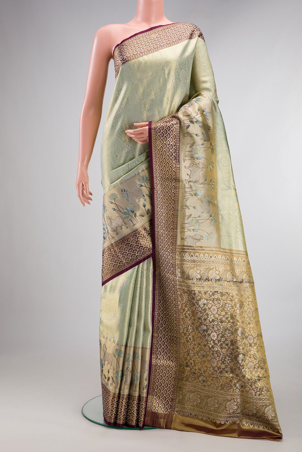 Pista Green Dual Tone Kanchipuram Tissue Saree with Zari Brocade on the body and Fancy Border.  displayed on a mannequin