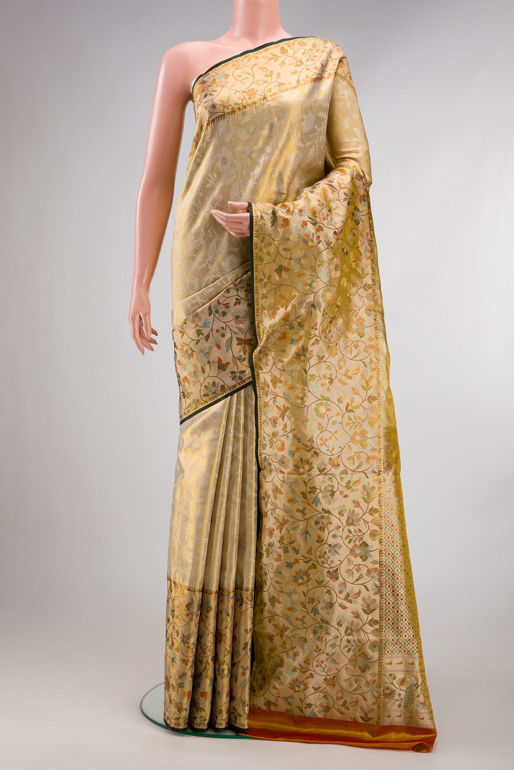Gold Dual Tone Kanchipuram Tissue Saree with Zari Brocade on the body and Fancy Border.  displayed on a mannequin