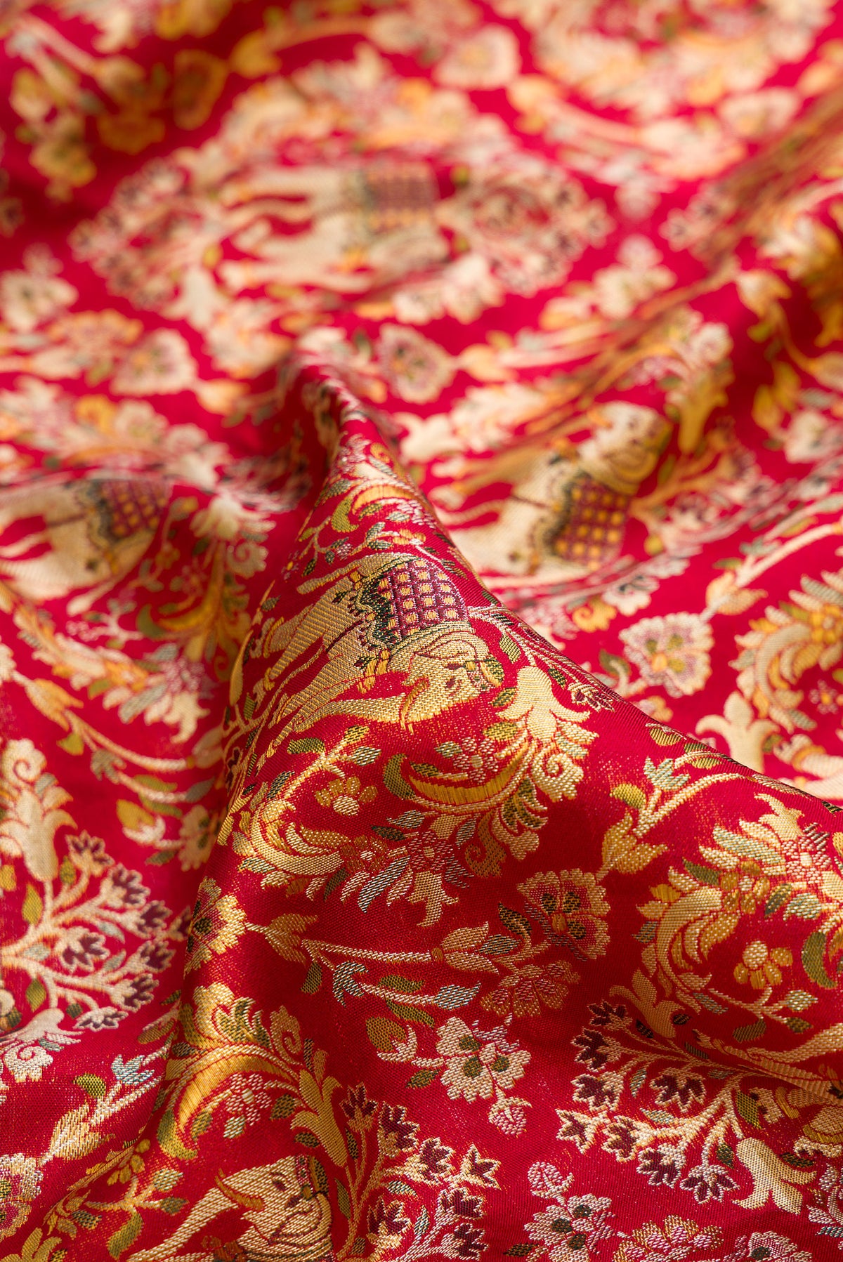 Close up of Deep Red Dual Tone Kanchipuram Tissue Saree with Zari Brocade on the body and Fancy Border.  displaying folds