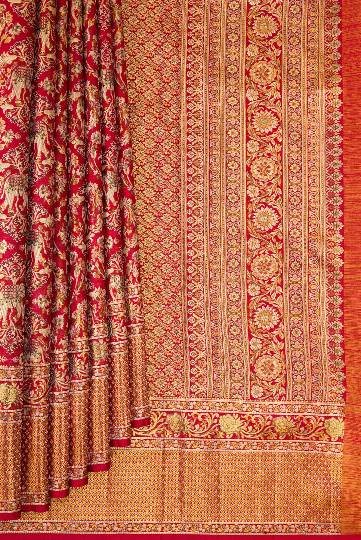Pleats and pallu of Deep Red Dual Tone Kanchipuram Tissue Saree with Zari Brocade on the body and Fancy Border. 