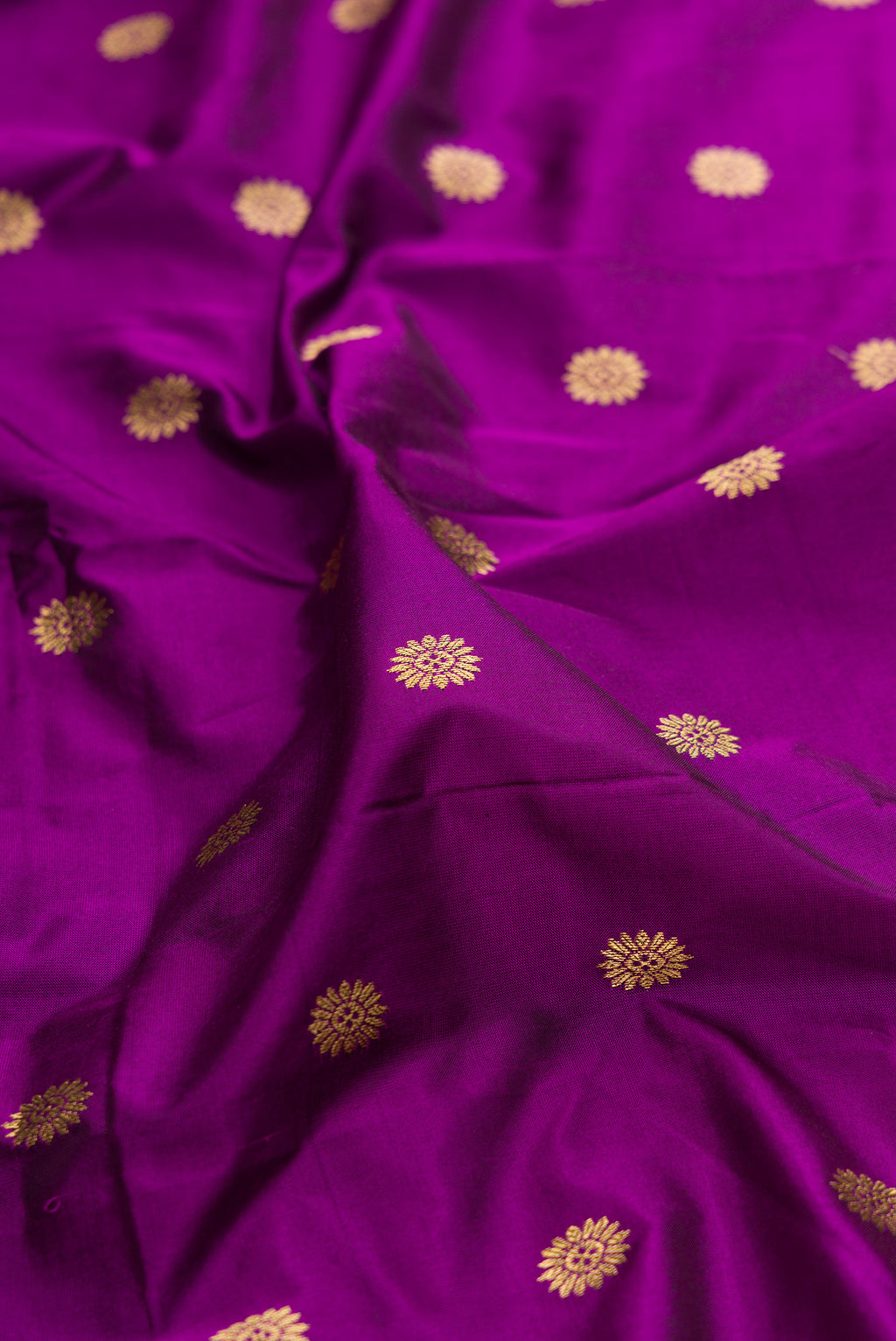 Close up of Pure Silk Purple Paithani Saree with Zari Butta on the body and Paithani Border.  displaying folds