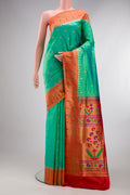 Pure Silk Sea Green Paithani Saree with Zari Butta on the body and Paithani Border.  displayed on a mannequin