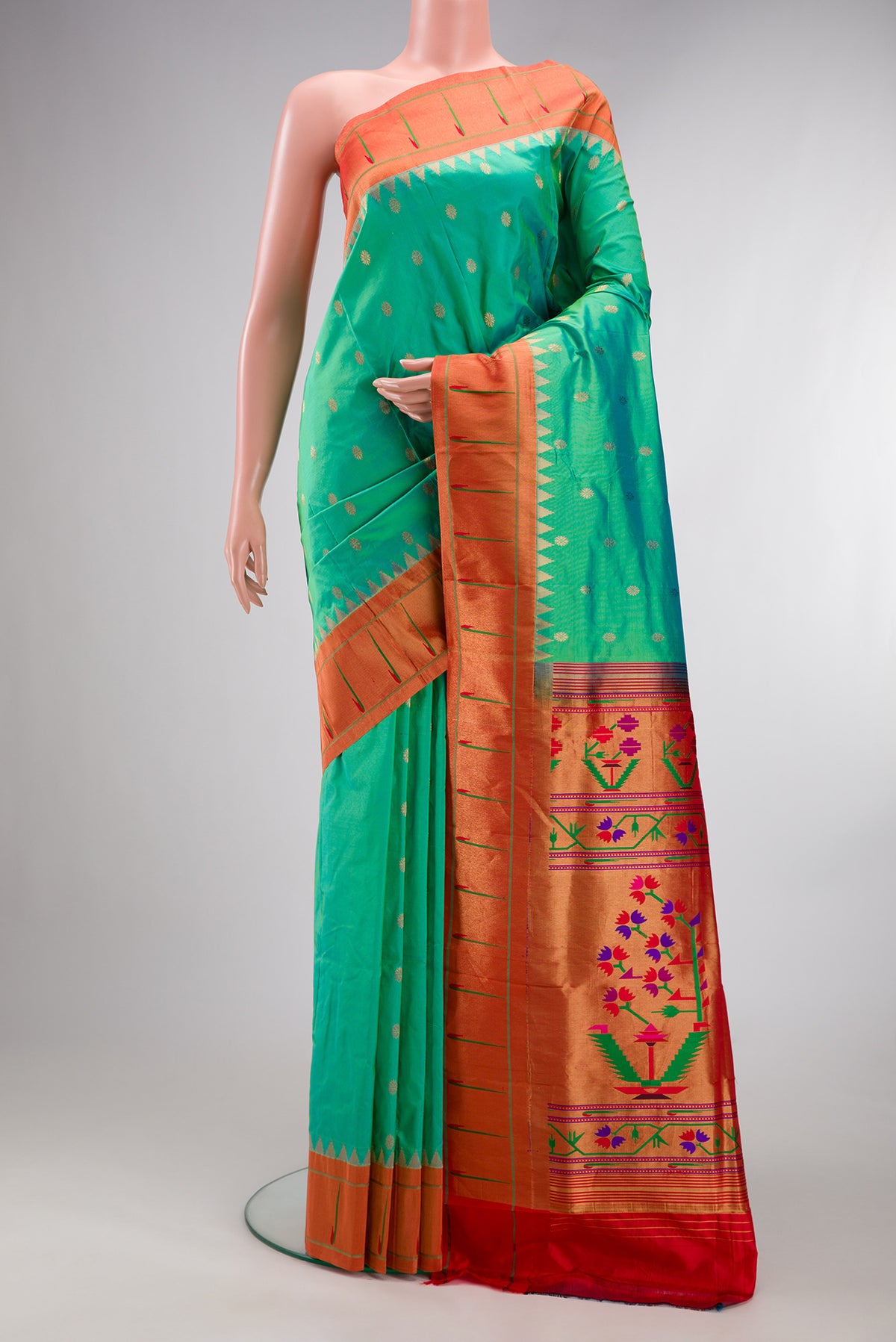 Pure Silk Sea Green Paithani Saree with Zari Butta on the body and Paithani Border.  displayed on a mannequin