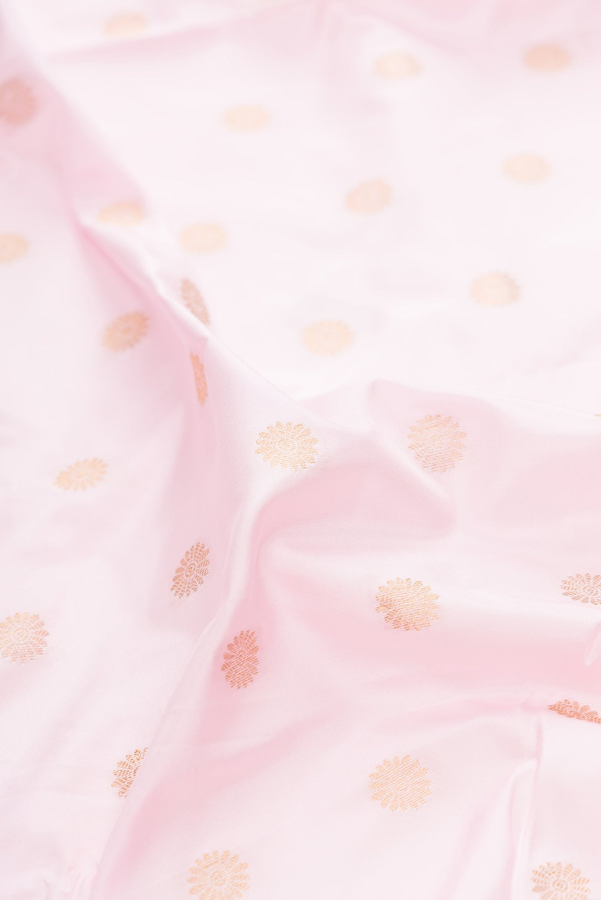 Close up of Pure Silk Rose pink Paithani Saree with Zari Butta on the body and Paithani Border.  displaying folds
