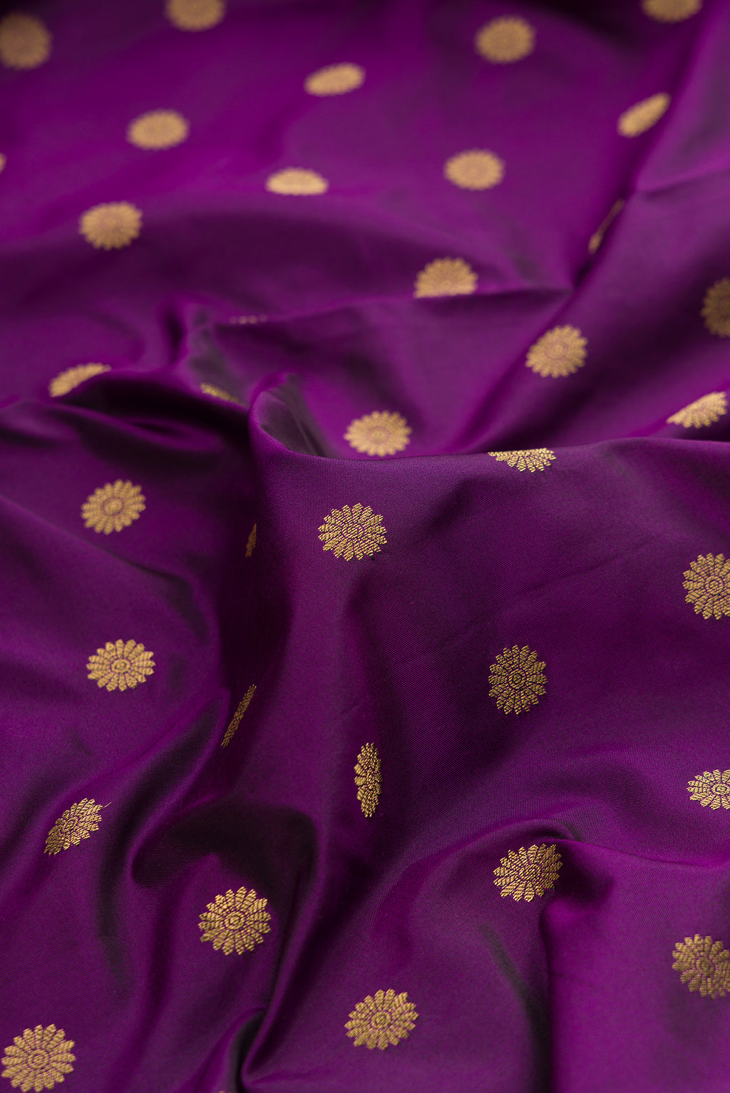 Close up of Pure Silk Violet Paithani Saree with Zari Butta on the body and Paithani Border.  displaying folds