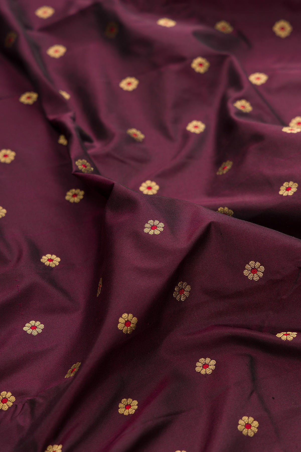 Close up of Pure Silk Coffee Brown Paithani Saree with Zari And Thread Butta on the body and Paithani Border.  displaying folds