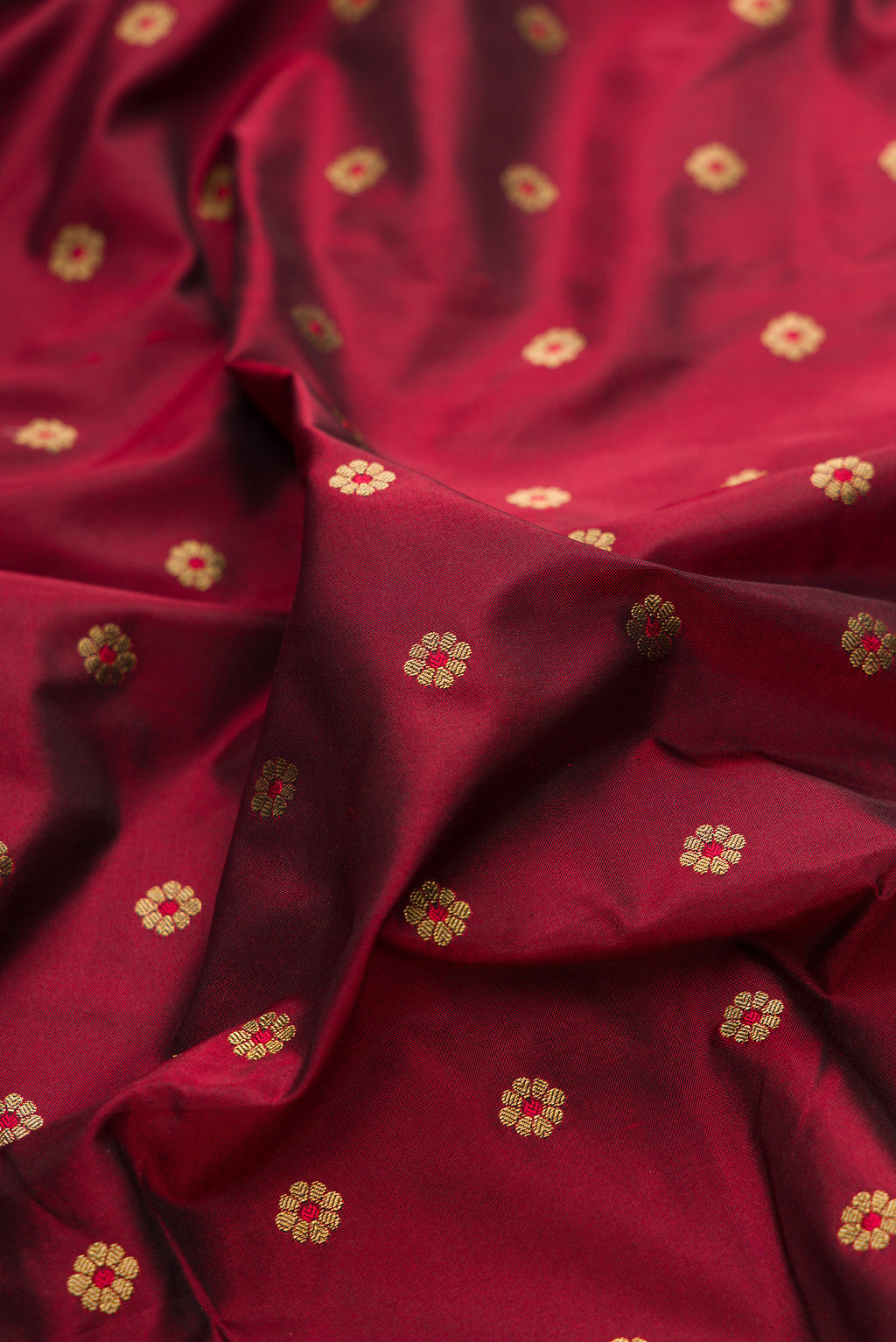 Close up of Pure Silk Maroon Paithani Saree with Zari And Thread Butta on the body and Paithani Border.  displaying folds