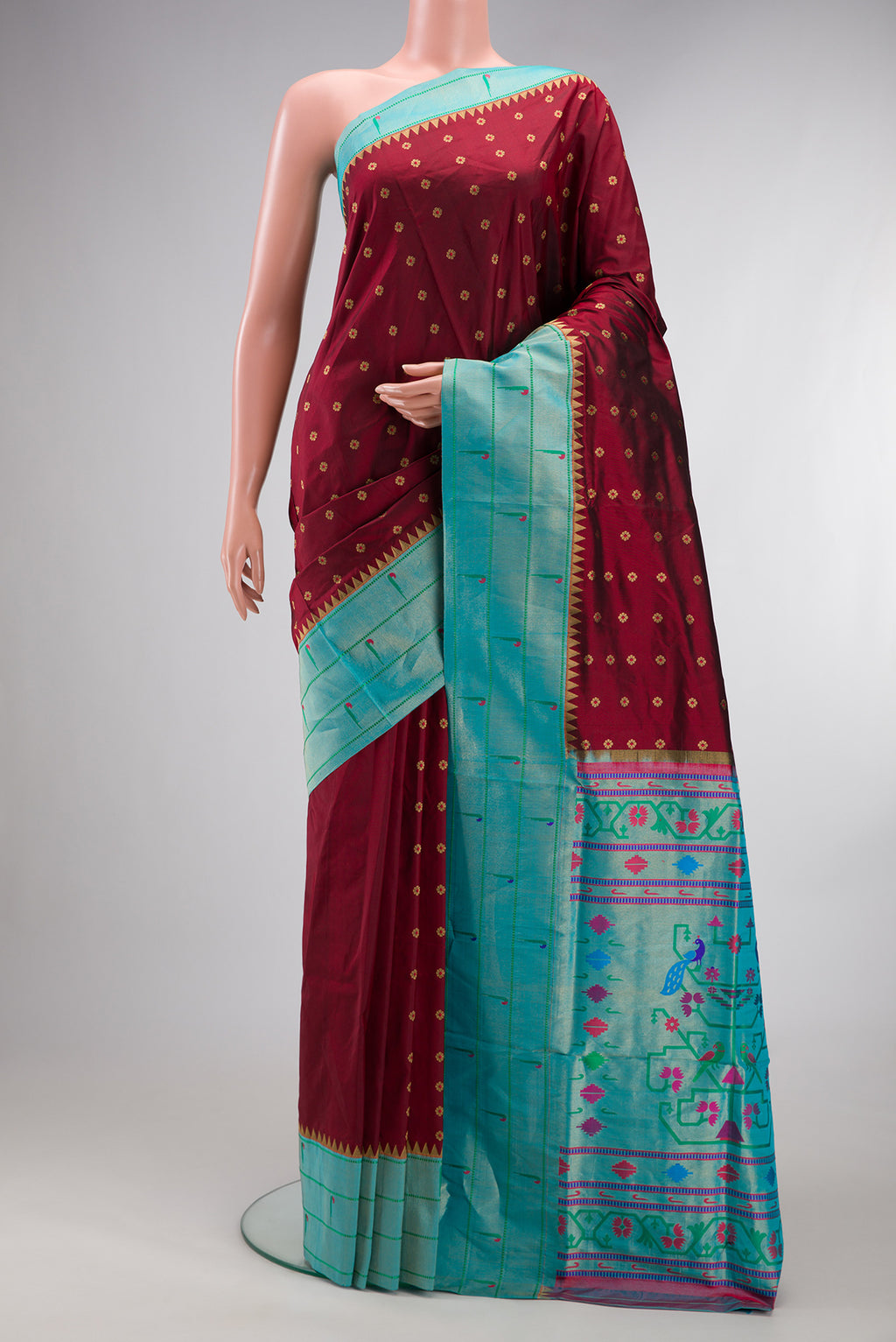 Pure Silk Maroon Paithani Saree with Zari And Thread Butta on the body and Paithani Border.  displayed on a mannequin