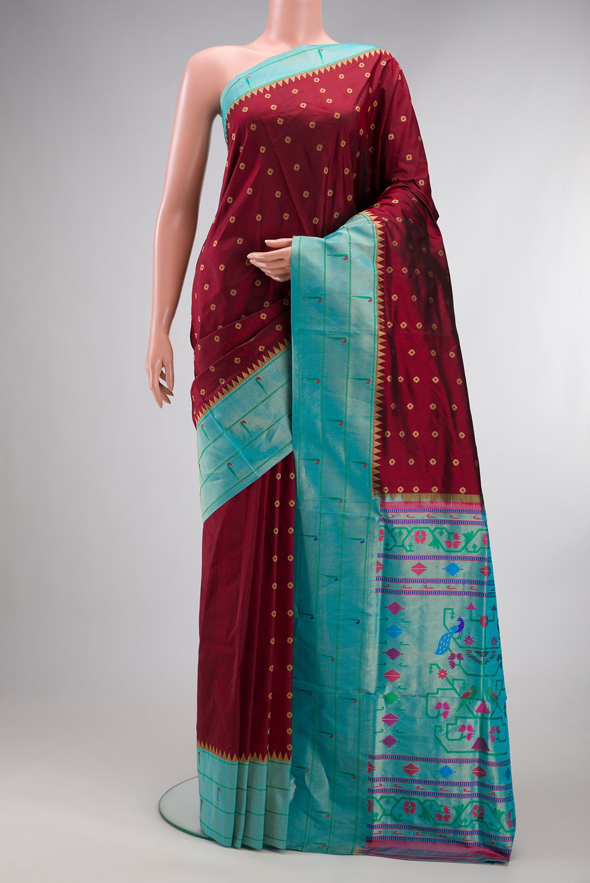 Pure Silk Maroon Paithani Saree with Zari And Thread Butta on the body and Paithani Border.  displayed on a mannequin