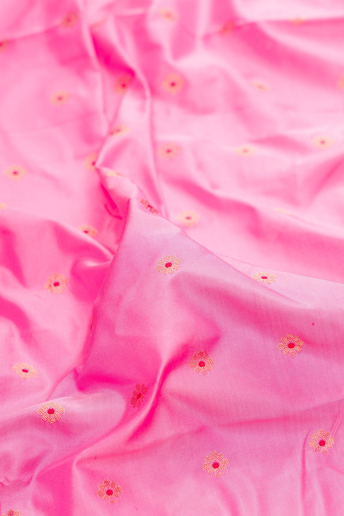 Close up of Pure Silk Rose pink Paithani Saree with Zari And Thread Butta on the body and Paithani Border.  displaying folds