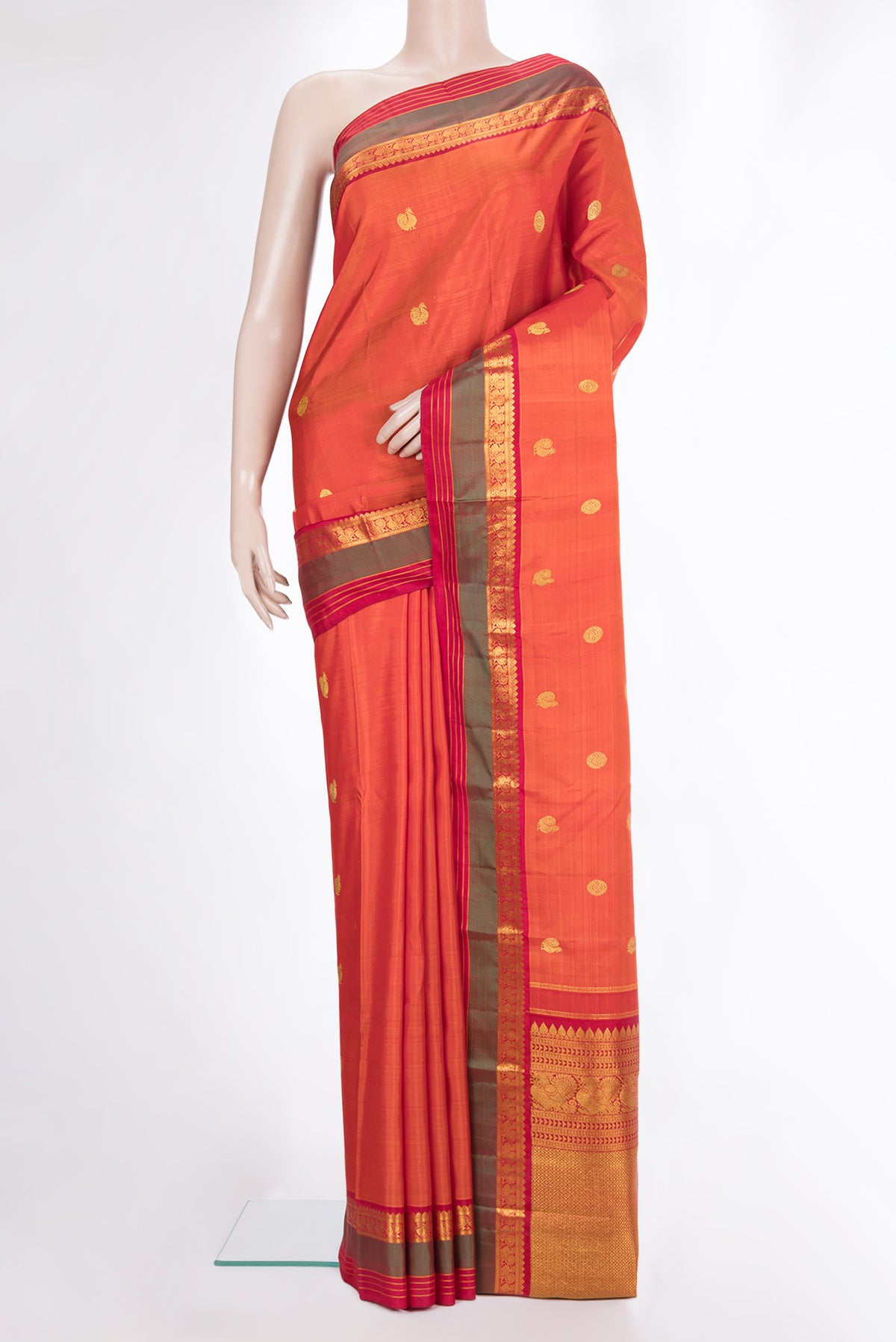 Pure Silk Orange Kanjivaram Saree with Zari Butta on the body and Zari Border.  displayed on a mannequin