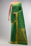 Pure Silk Green Kanjivaram Saree with Jacquard design on the body and Zari Border.  displayed on a mannequin