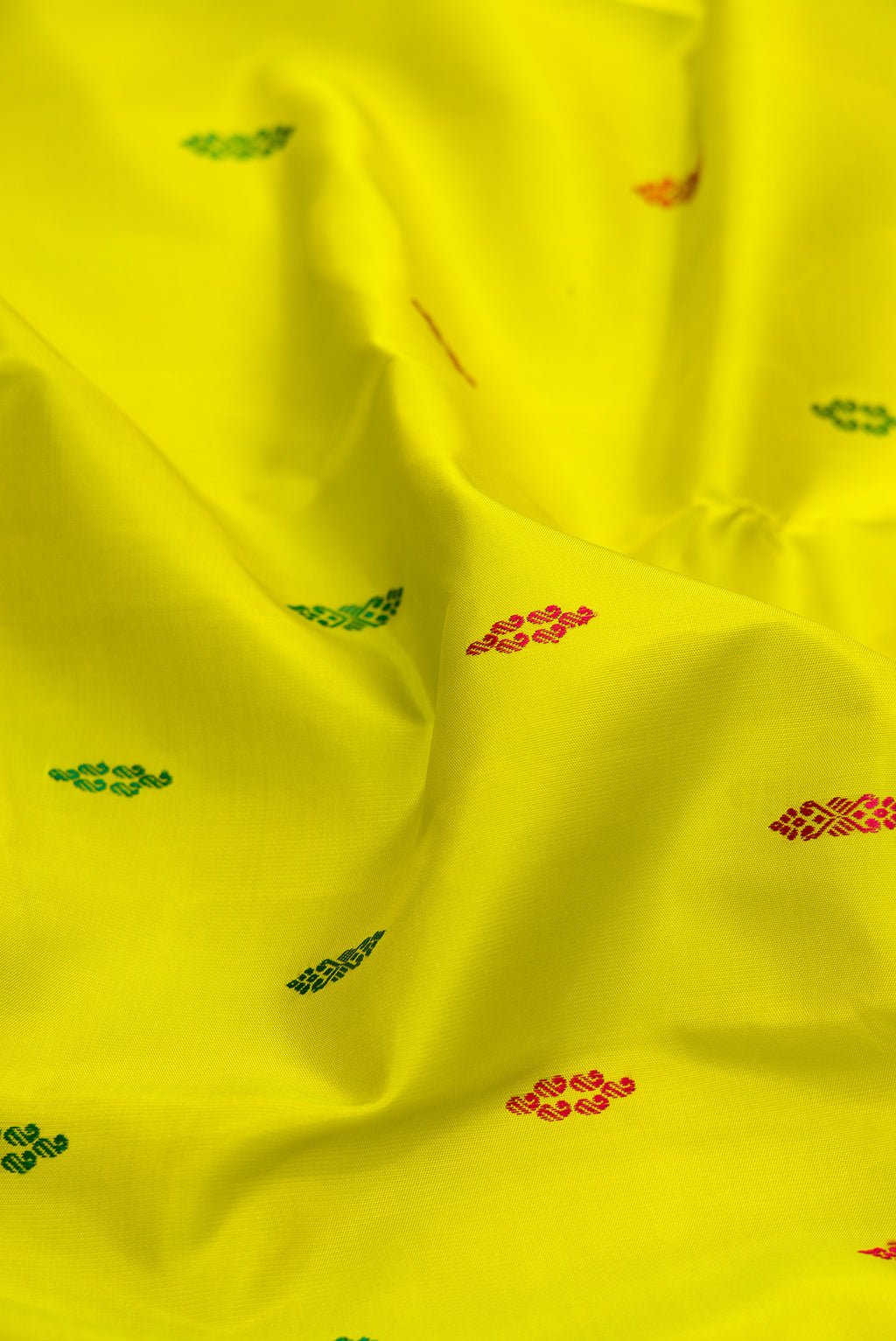 Close up of Pure Silk Green Dual Tone Kanjivaram Saree with Thread Butta on the body and Zari Border.  displaying folds