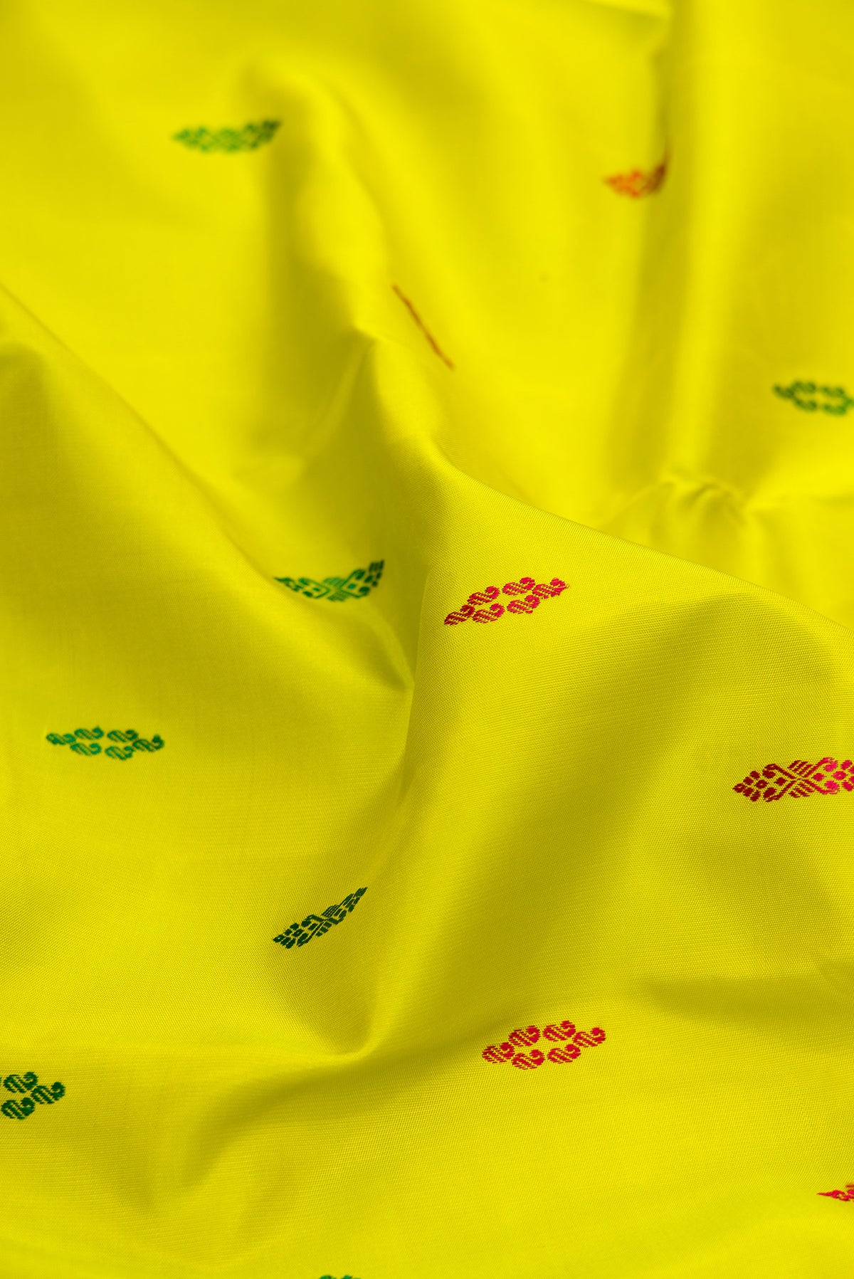Close up of Pure Silk Green Dual Tone Kanjivaram Saree with Thread Butta on the body and Zari Border.  displaying folds