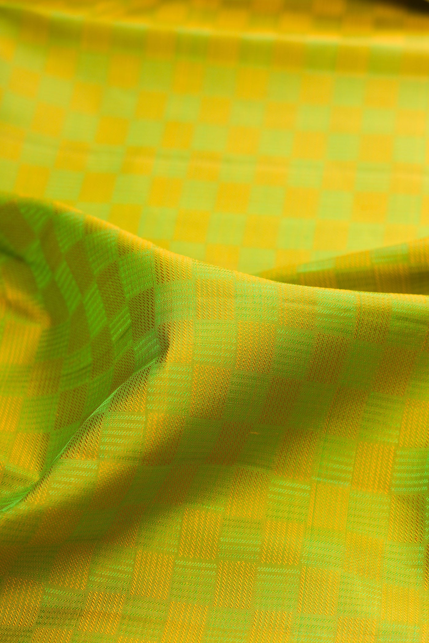 Close up of Pure Silk Parrot Green Kanchipuram Saree with Jacquard design on the body and Zari Border.  displaying folds
