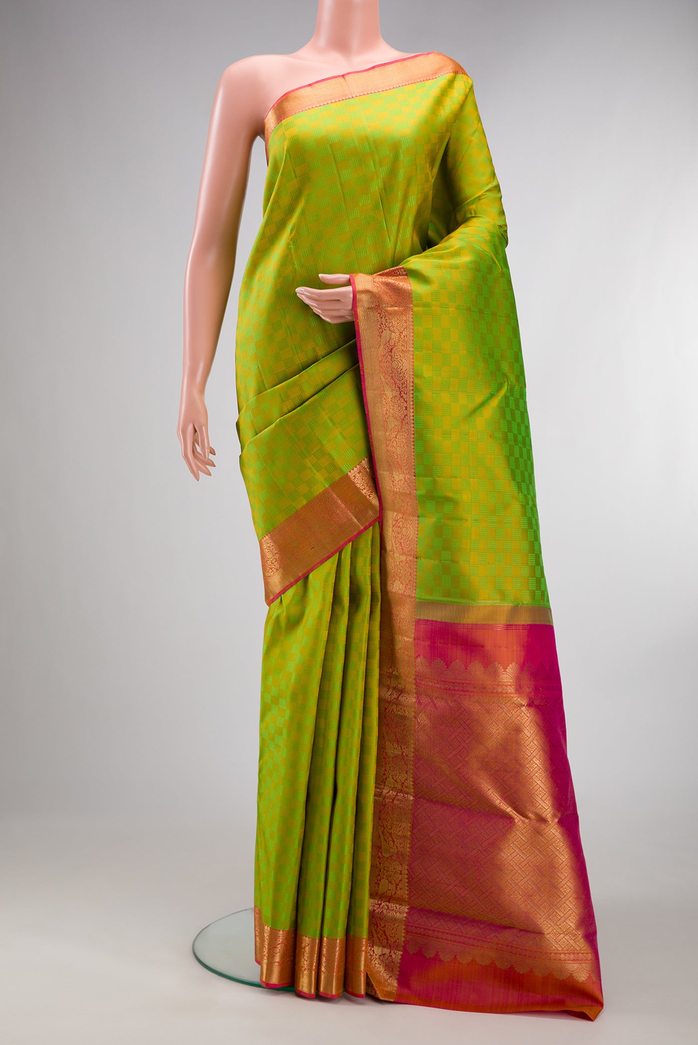 Pure Silk Parrot Green Kanchipuram Saree with Jacquard design on the body and Zari Border.  displayed on a mannequin