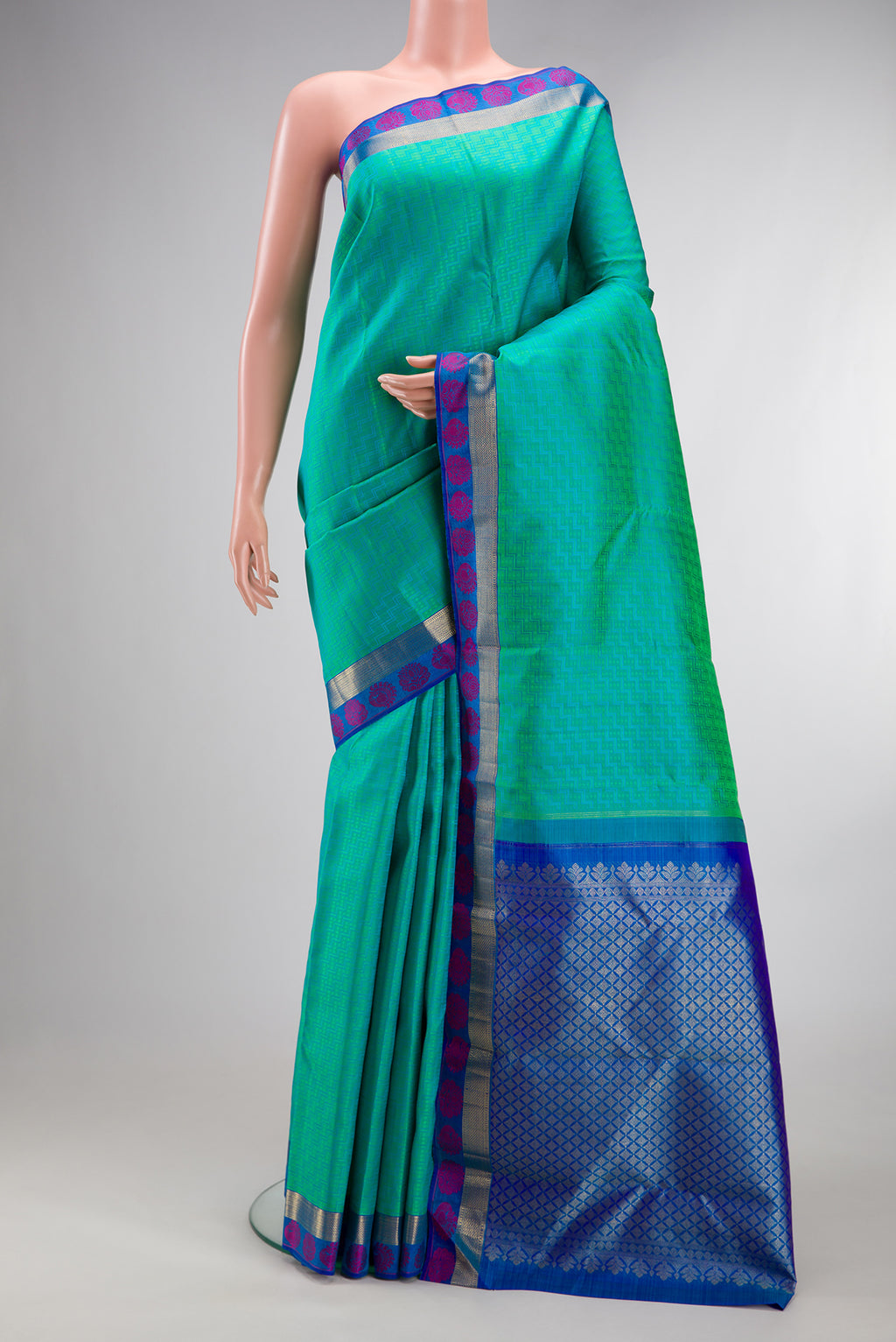 Pure Silk Sea Green Kanchipuram Saree with Jacquard design on the body and Fancy Border.  displayed on a mannequin