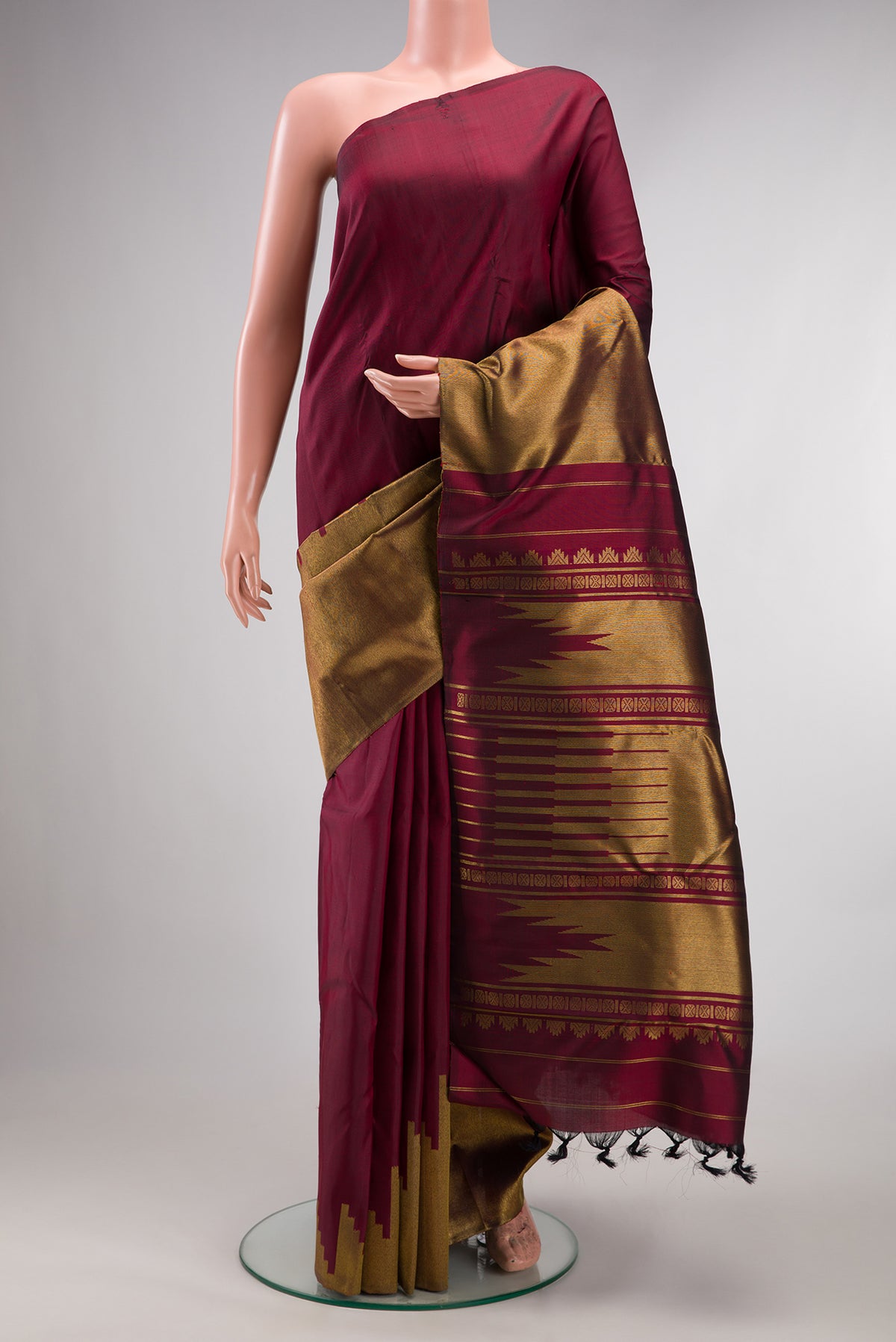 Pure Silk Pure Zari Maroon Dual Tone Kanjivaram Saree with Plain Body and Rising Temple Border.  displayed on a mannequin