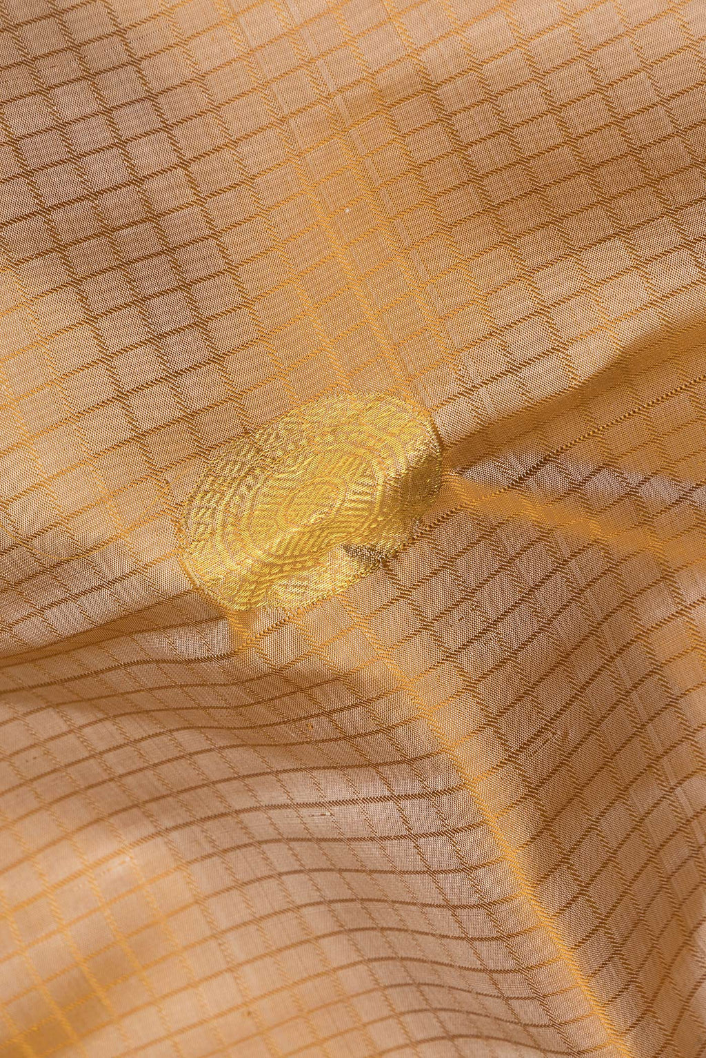 Close up of Pure Silk Beige Dual Tone Kanchipuram Saree with Checked design on the body and Zari Border.  displaying folds