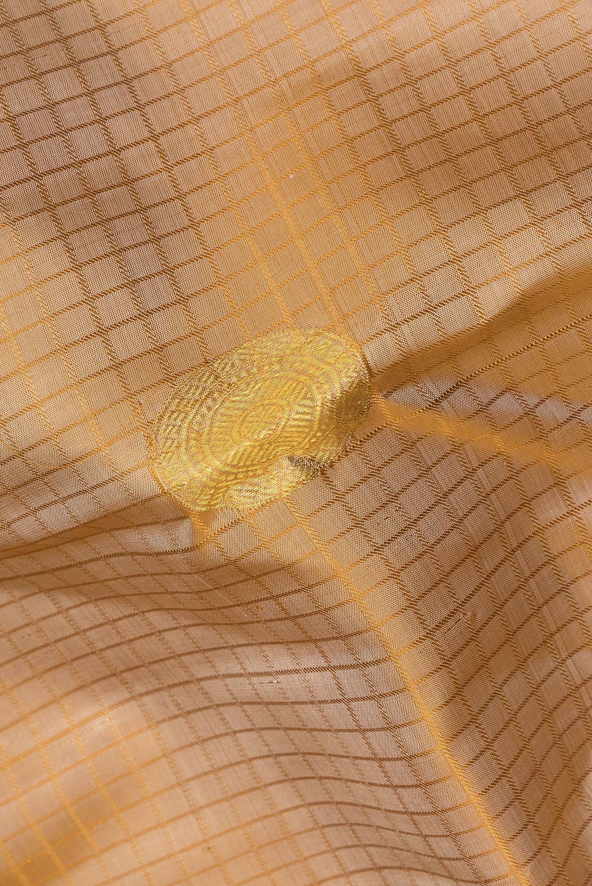Close up of Pure Silk Beige Dual Tone Kanchipuram Saree with Checked design on the body and Zari Border.  displaying folds