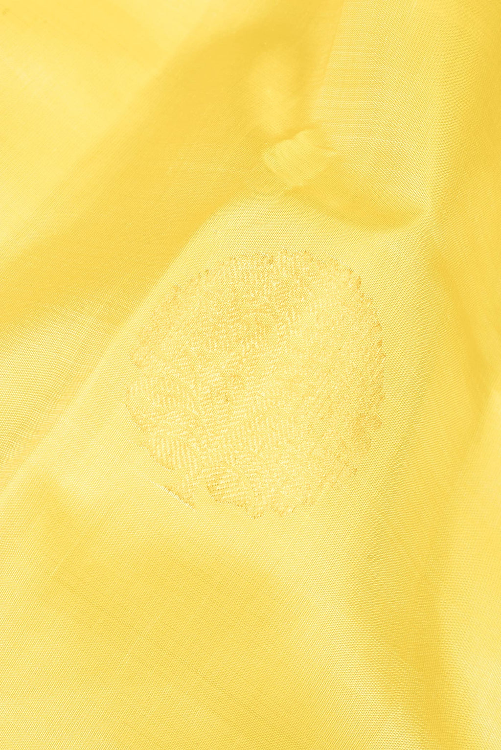 Close up of Pure Silk Yellow Kanjivaram Saree with Zari Butta on the body and Zari Border.  displaying folds