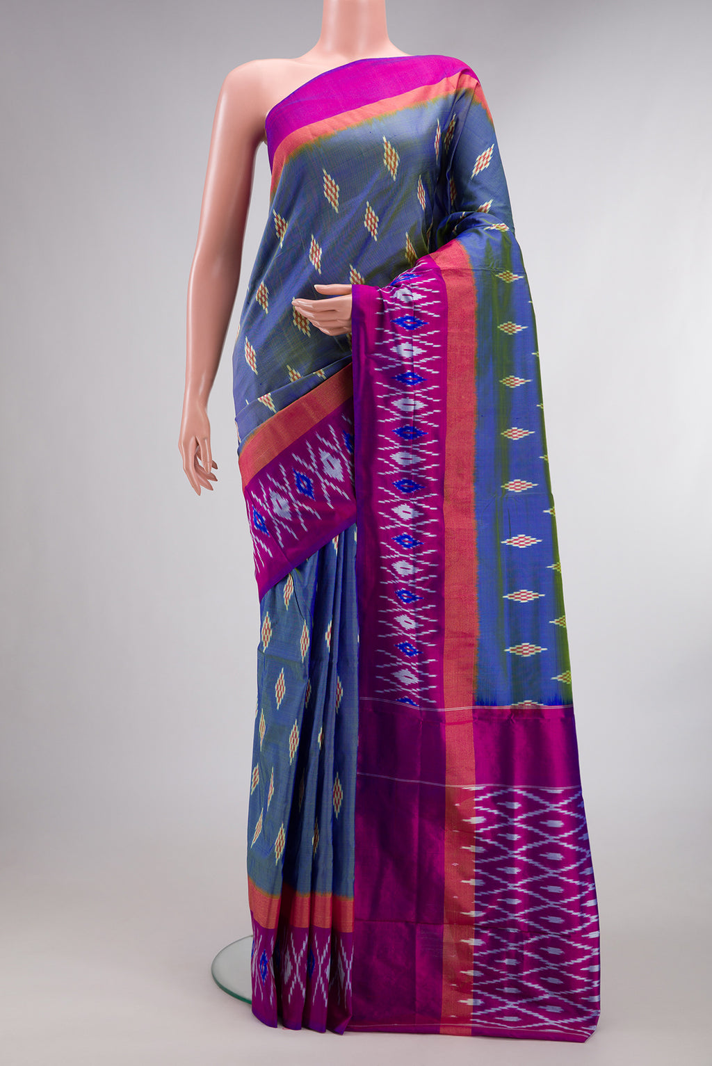 Pure Silk Maya Blue Dual Tone Pochampally Saree with Ikat design on the body and Ikat Border.  displayed on a mannequin