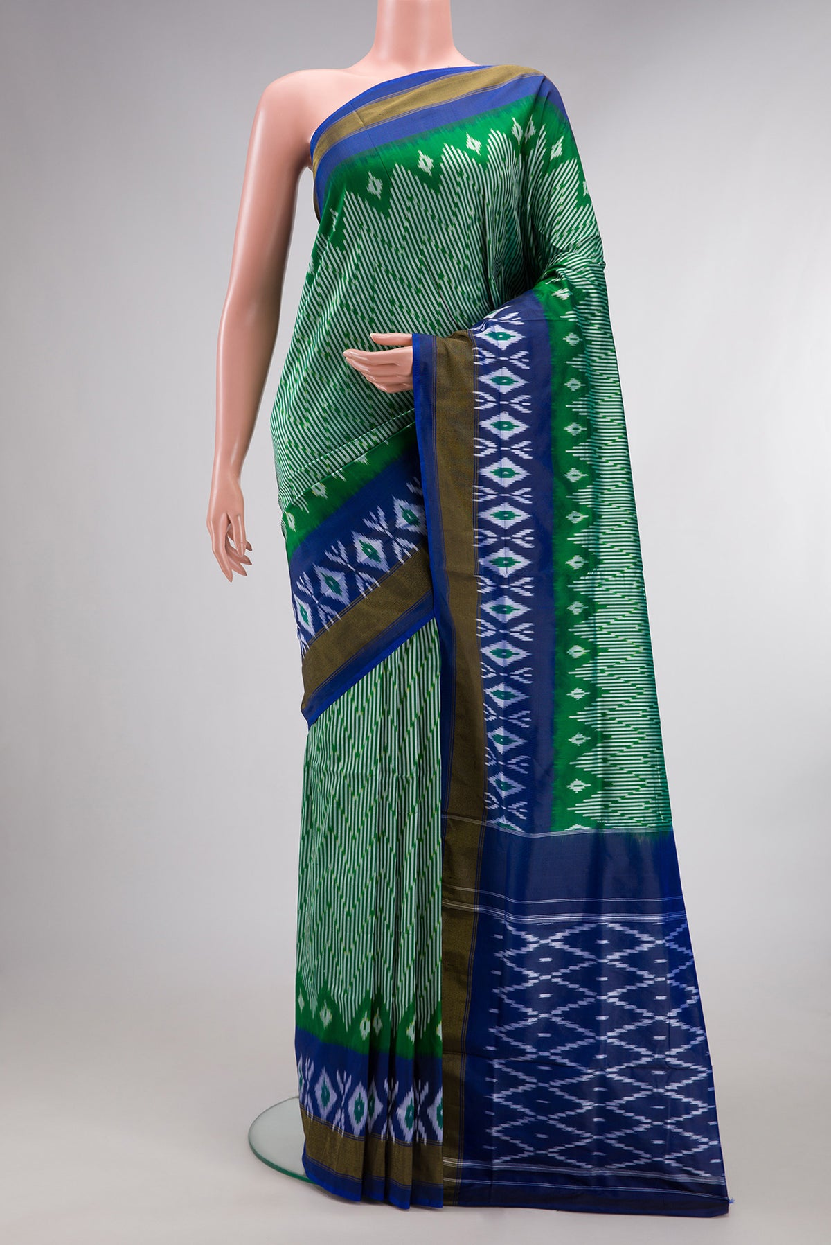 Pure Silk Green Pochampally Saree with Ikat design on the body and Ikat Border.  displayed on a mannequin