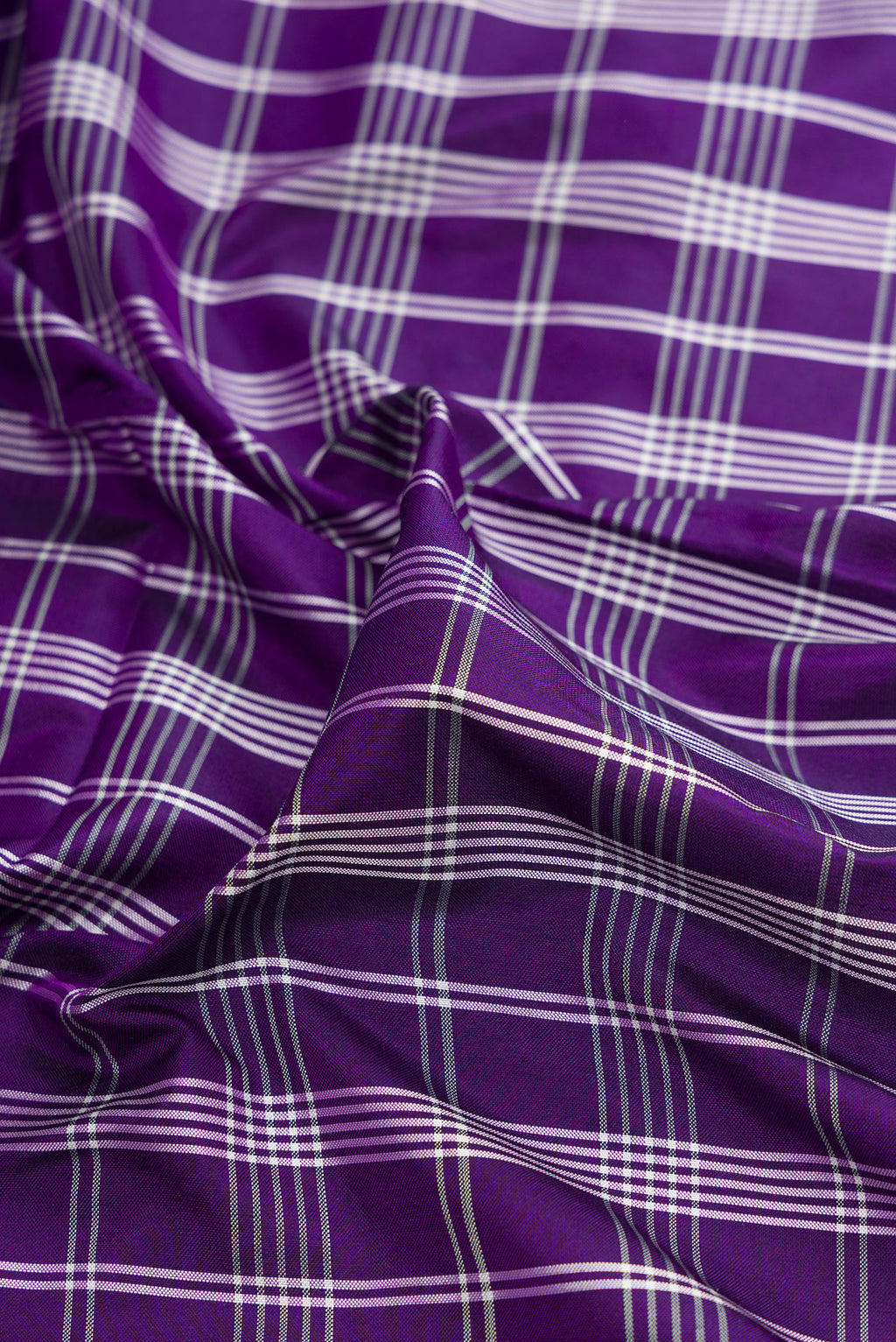 Close up of Pure Silk Purple Pochampally Saree with Checked design on the body and Zari Border.  displaying folds
