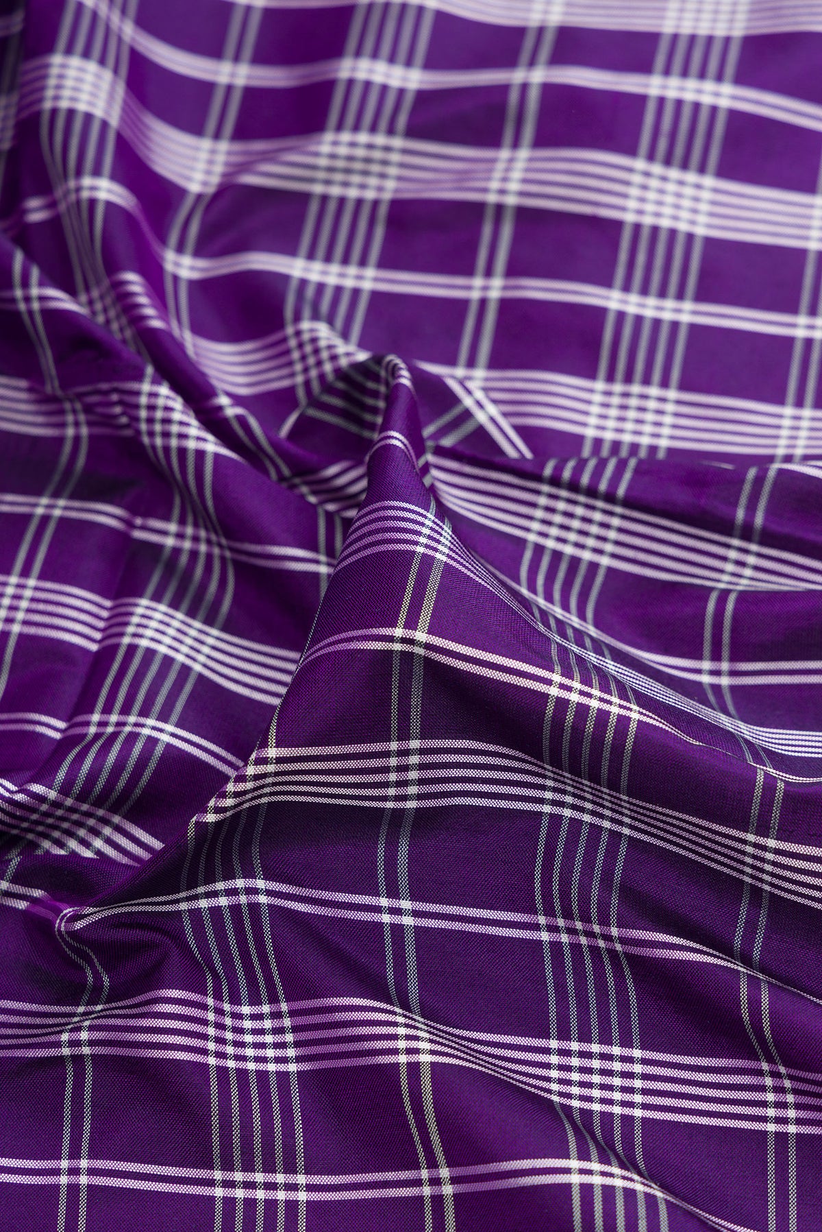 Close up of Pure Silk Purple Pochampally Saree with Checked design on the body and Zari Border.  displaying folds