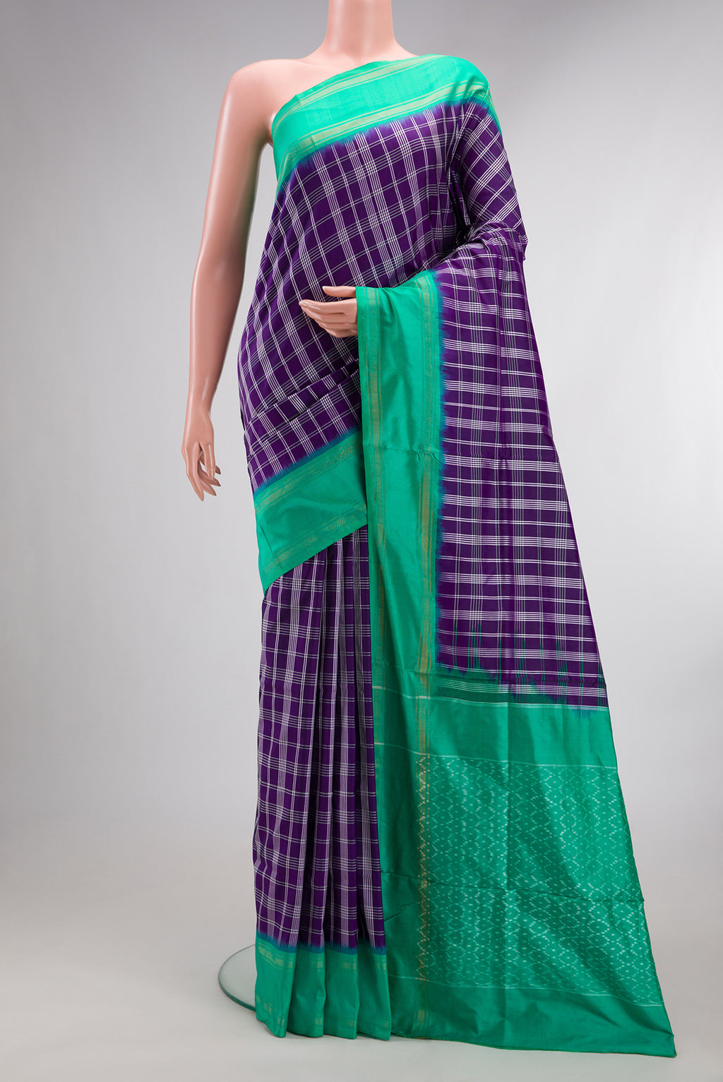 Pure Silk Purple Pochampally Saree with Checked design on the body and Zari Border.  displayed on a mannequin