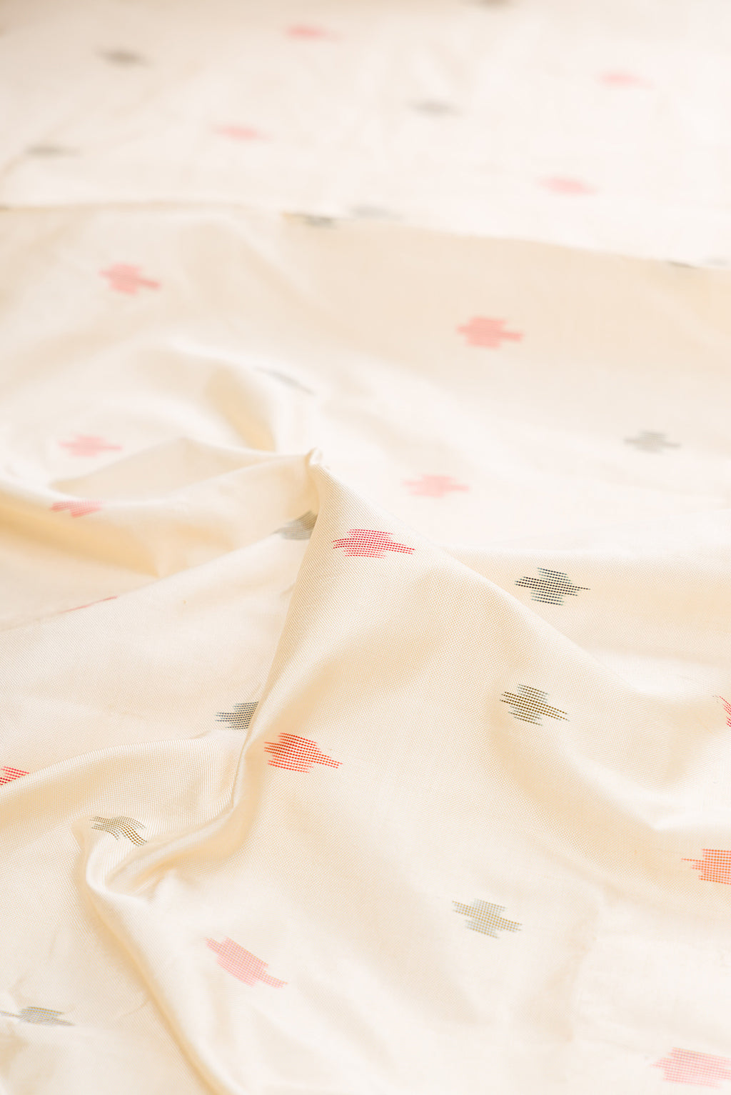 Close up of Pure Silk Off White Pochampally Saree with Pure Ikat on the body and Ikat Border.  displaying folds