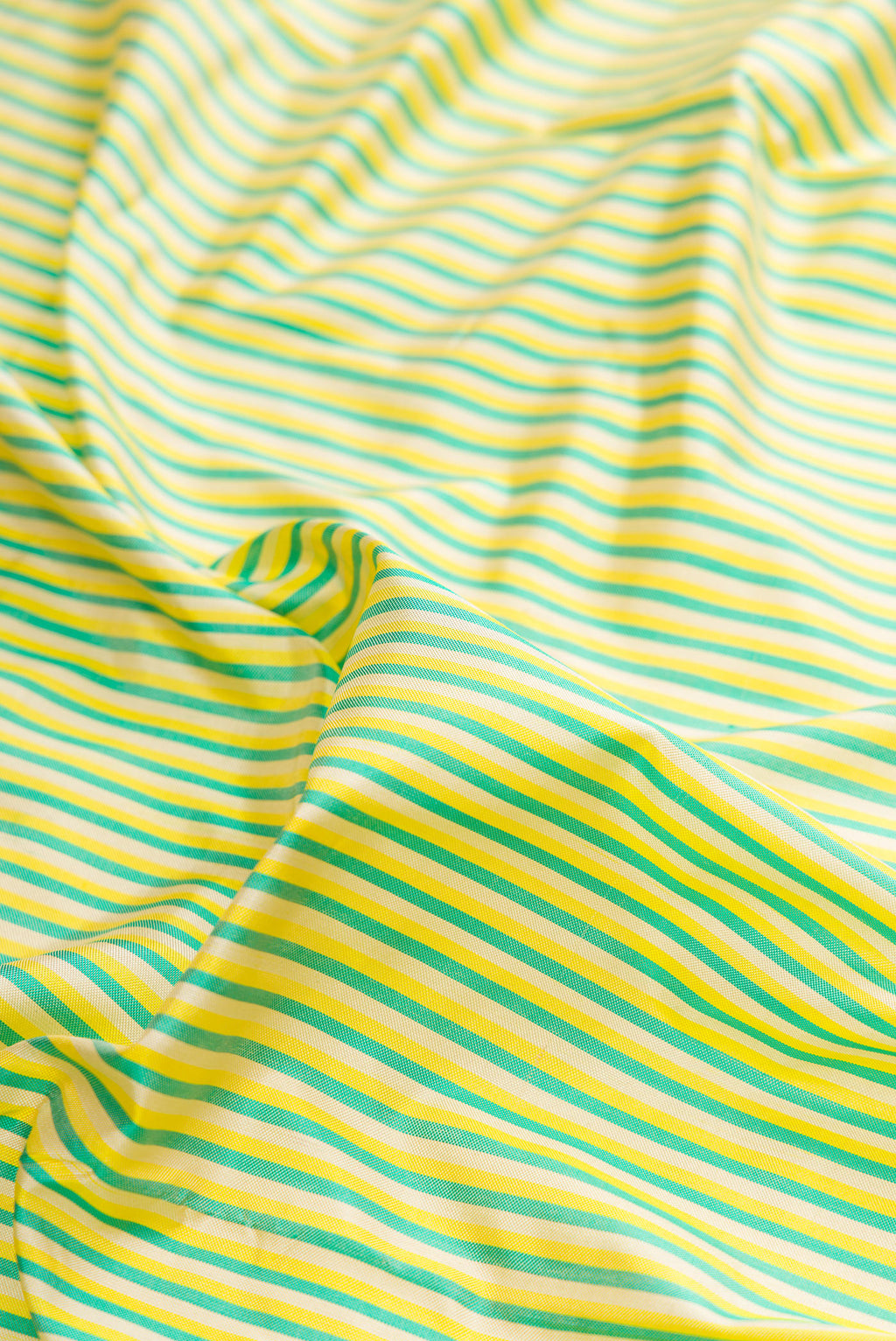 Close up of Pure Silk Multi Color Pochampally Saree with Stripes on the body and Zari Border.  displaying folds