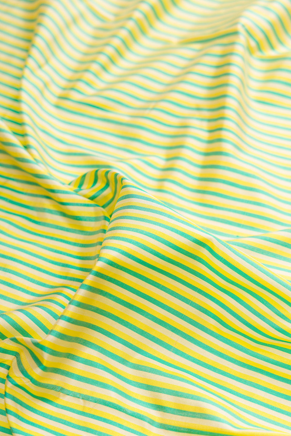 Close up of Pure Silk Multi Color Pochampally Saree with Stripes on the body and Zari Border.  displaying folds