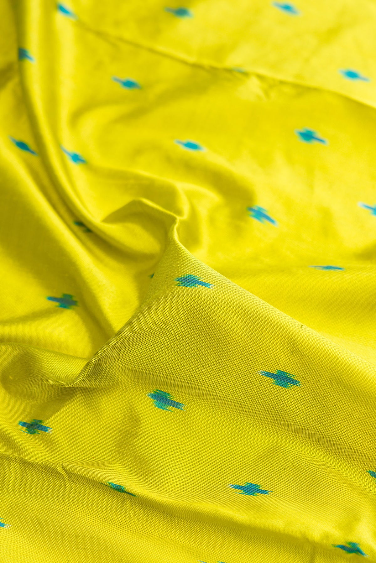Close up of Pure Silk Parrot Green Pochampally Saree with Pure Ikat on the body and Ikat Border.  displaying folds