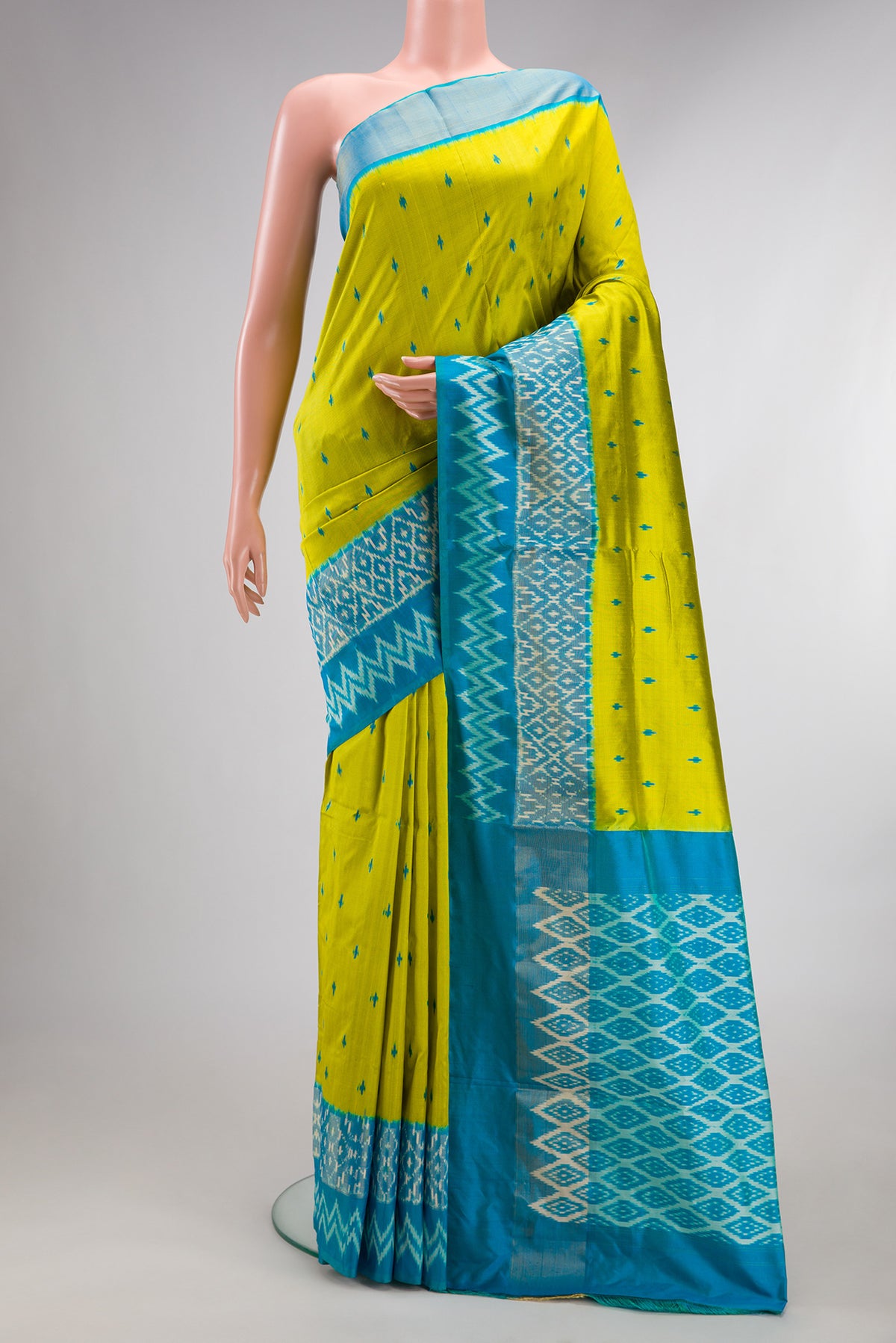 Pure Silk Parrot Green Pochampally Saree with Pure Ikat on the body and Ikat Border.  displayed on a mannequin