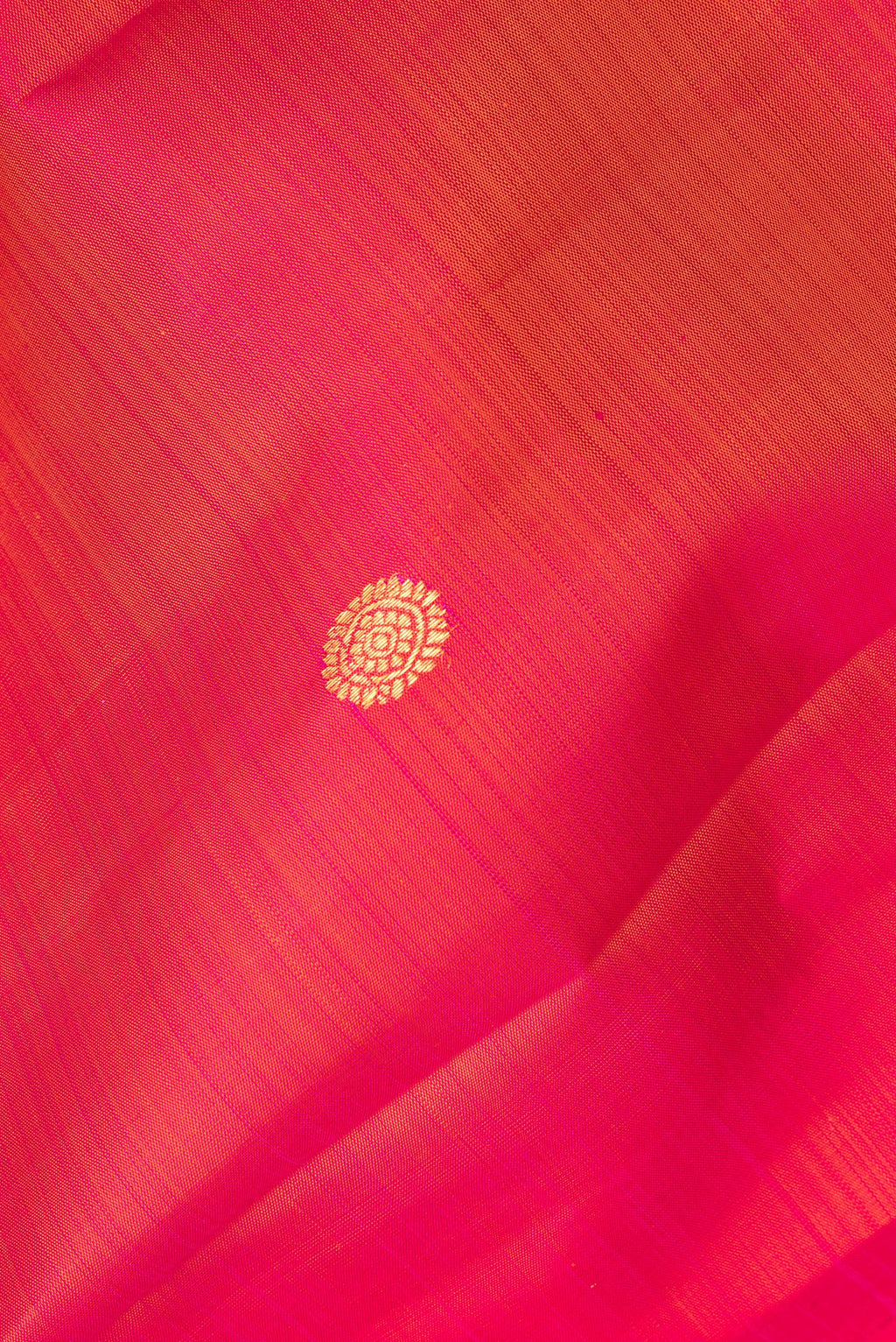Close up of Pure Silk Coral Dual Tone Kanjivaram Saree with Zari Butta on the body and Plain Border.  displaying folds