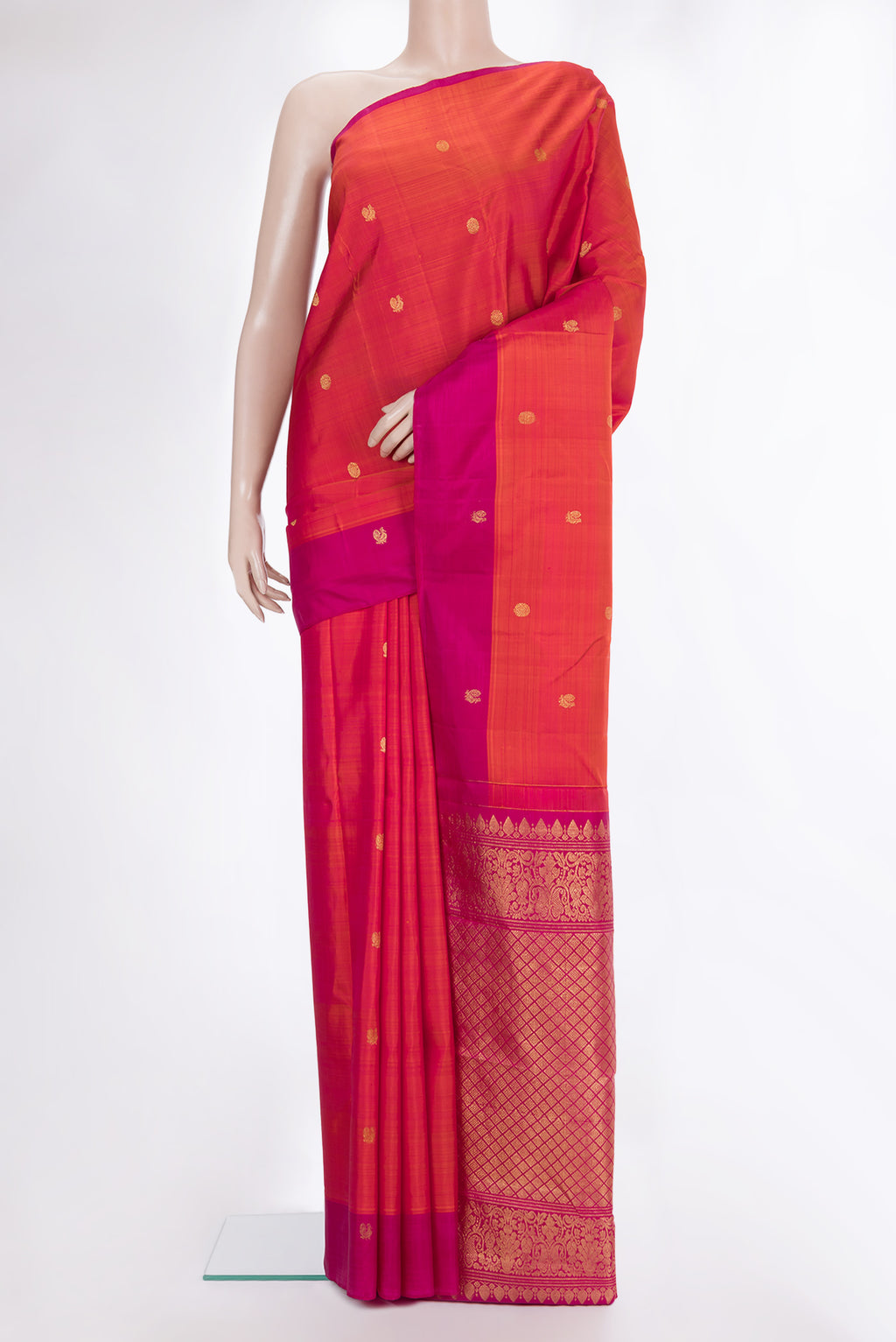 Pure Silk Coral Dual Tone Kanjivaram Saree with Zari Butta on the body and Plain Border.  displayed on a mannequin