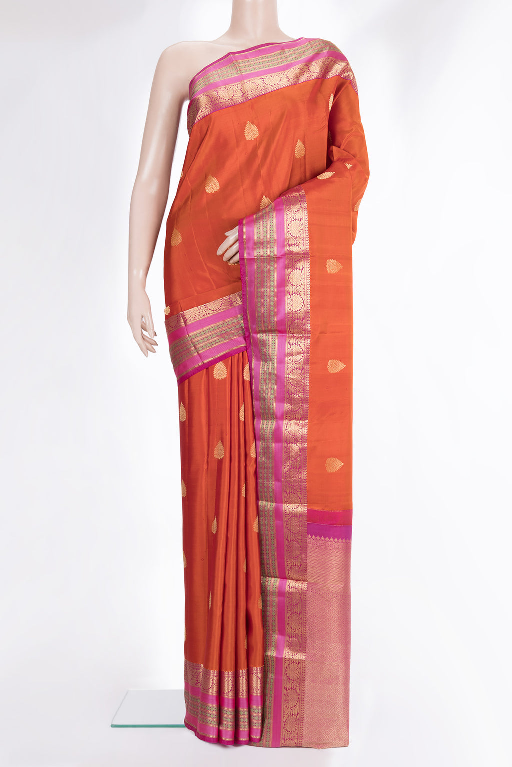 Pure Silk Orange Kanjivaram Saree with Zari Butta on the body and Zari And Thread Border.  displayed on a mannequin