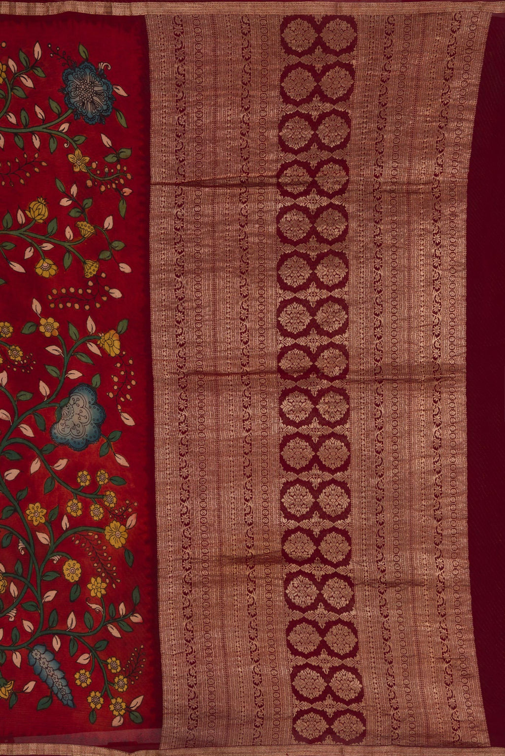 Close up image of the pallu of Deep Red Mysore Chiffon Saree with kalamkari Print on the body and Zari Border. 