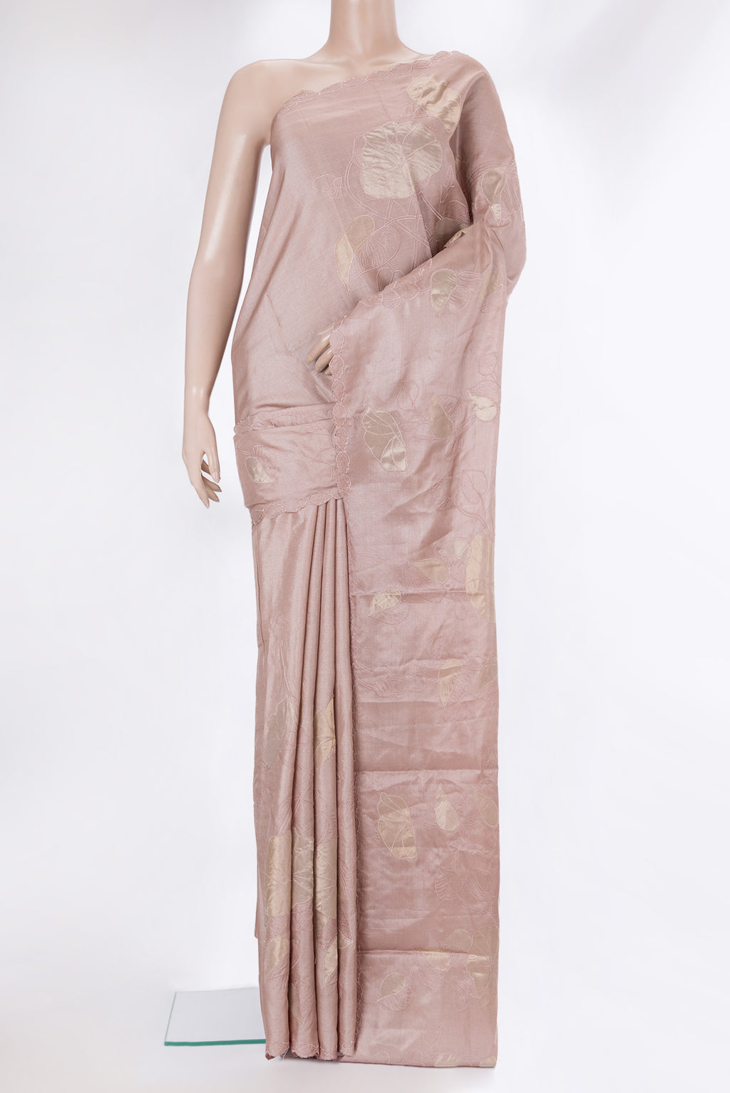 Rose Gold Tussar Saree with Embroidery on the body and Embroidery Border.  displayed on a mannequin