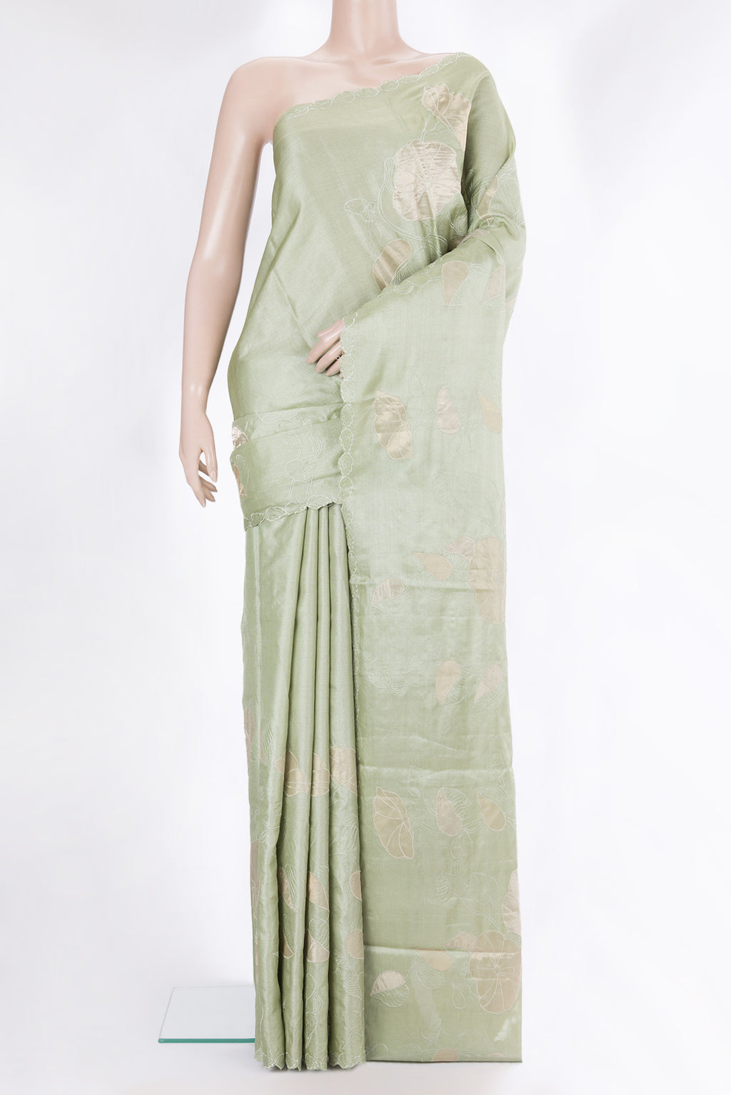 Pista Green Tussar Saree with Embroidery on the body and Embroidery Border.  displayed on a mannequin