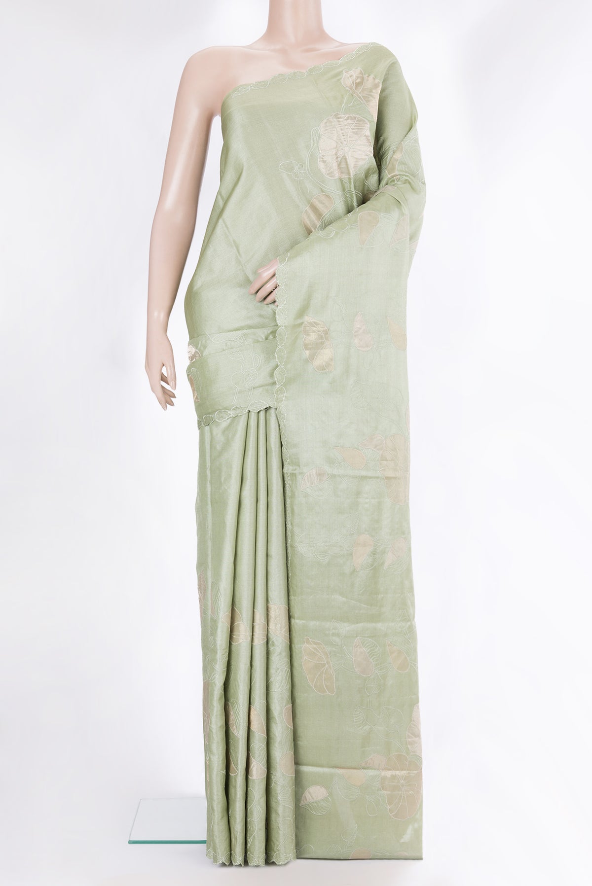 Pista Green Tussar Saree with Embroidery on the body and Embroidery Border.  displayed on a mannequin