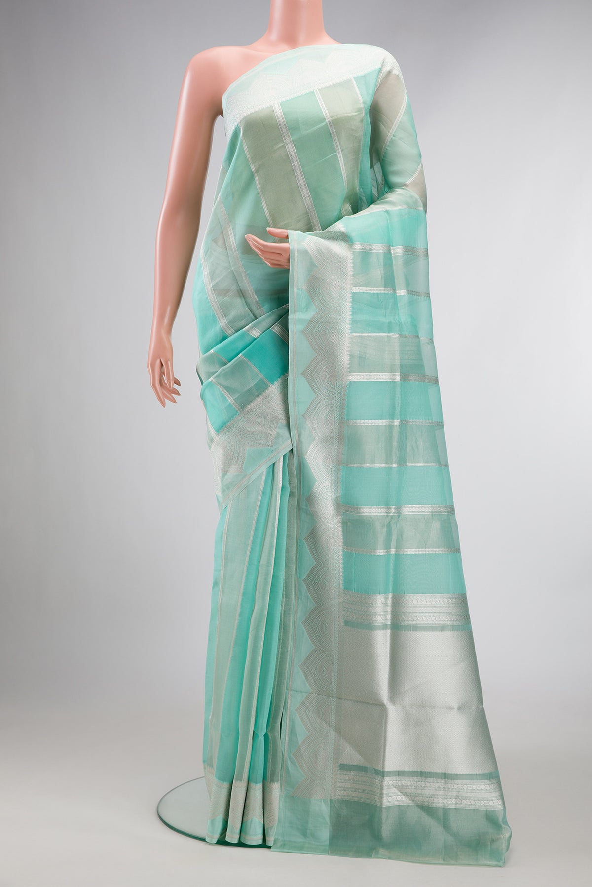 Turquoise Dual Tone Banarasi Kora Saree with Stripes on the body and Zari Border.  displayed on a mannequin