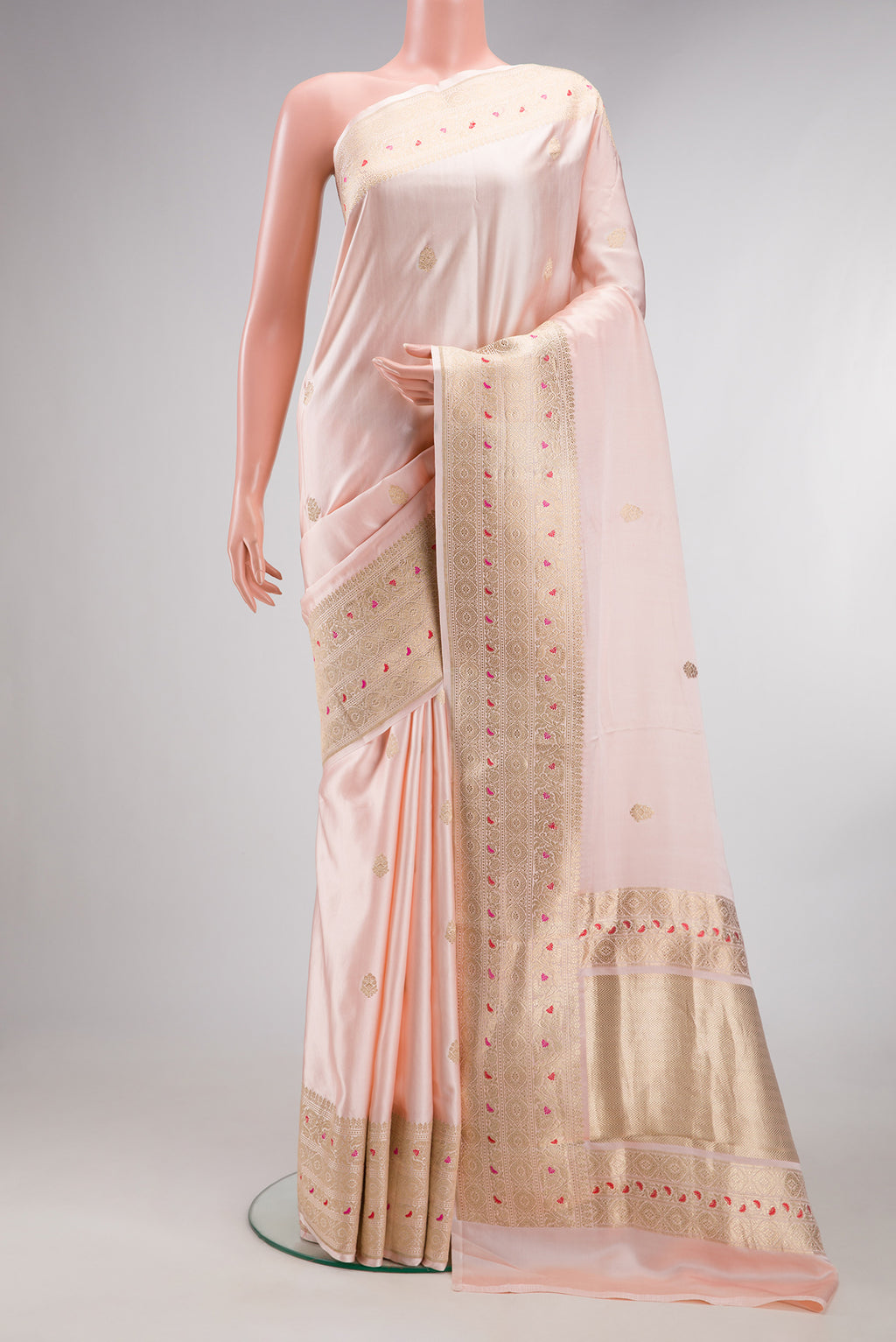 Pure Silk Peach Dual Tone Banarasi Saree with Zari Butta on the body and Fancy Border.  displayed on a mannequin