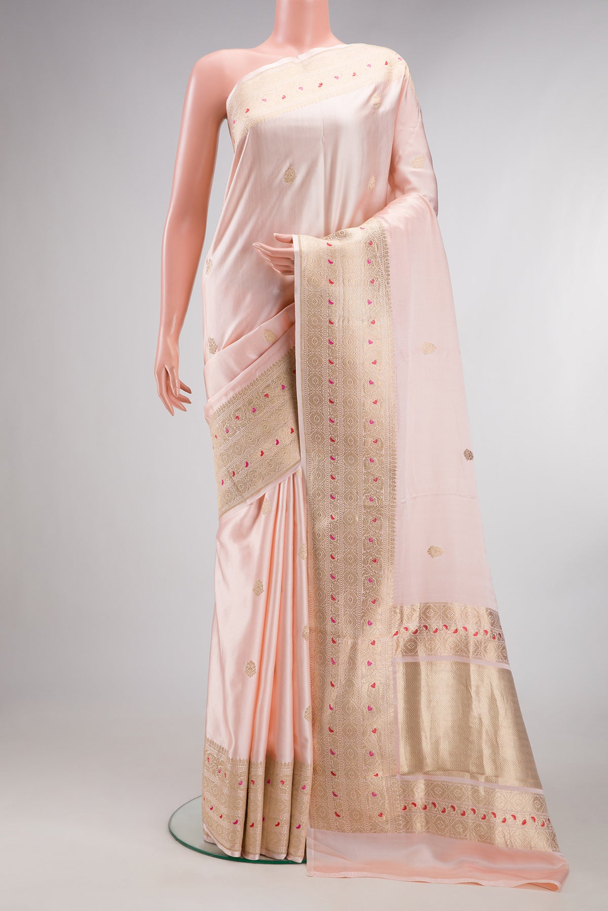 Pure Silk Peach Dual Tone Banarasi Saree with Zari Butta on the body and Fancy Border.  displayed on a mannequin