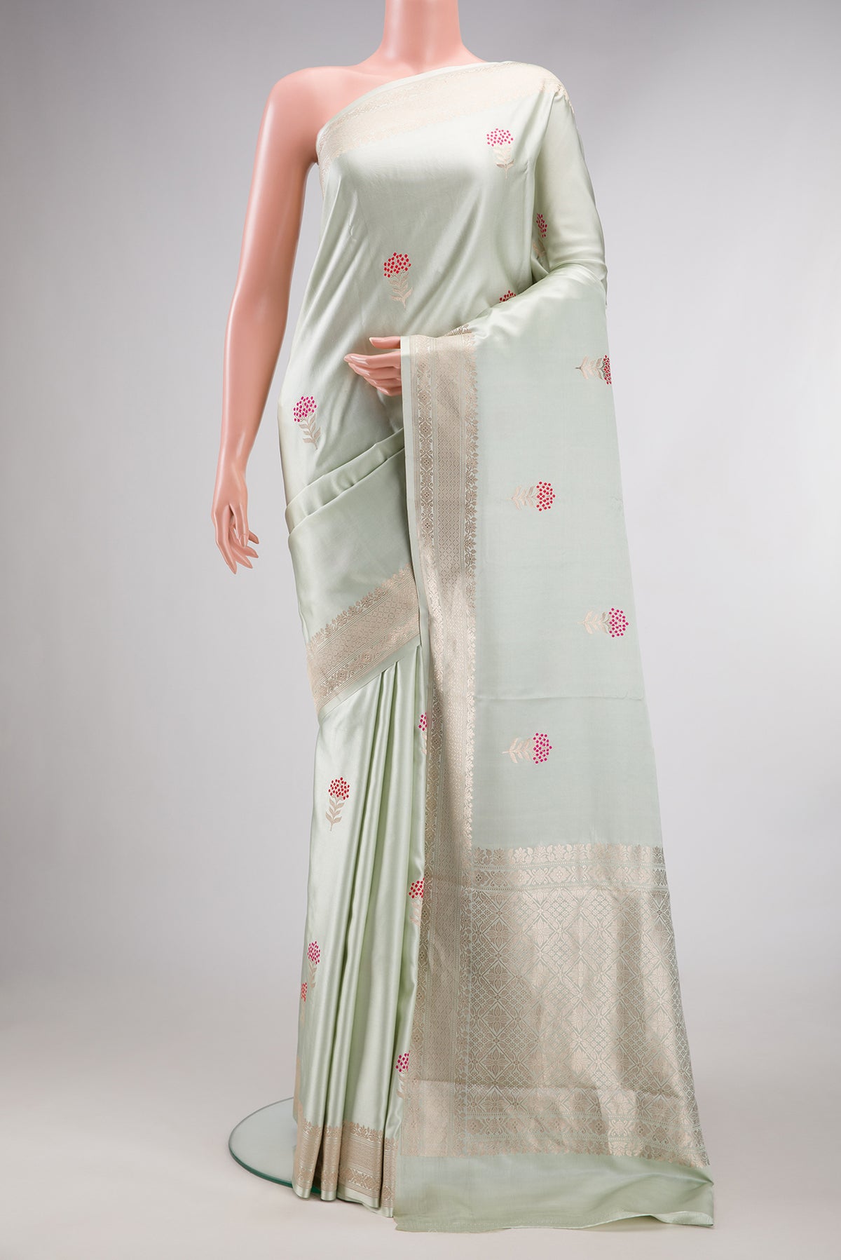 Pure Silk Light Green Dual Tone Banarasi Saree with Zari And Thread Butta on the body and Fancy Border.  displayed on a mannequin