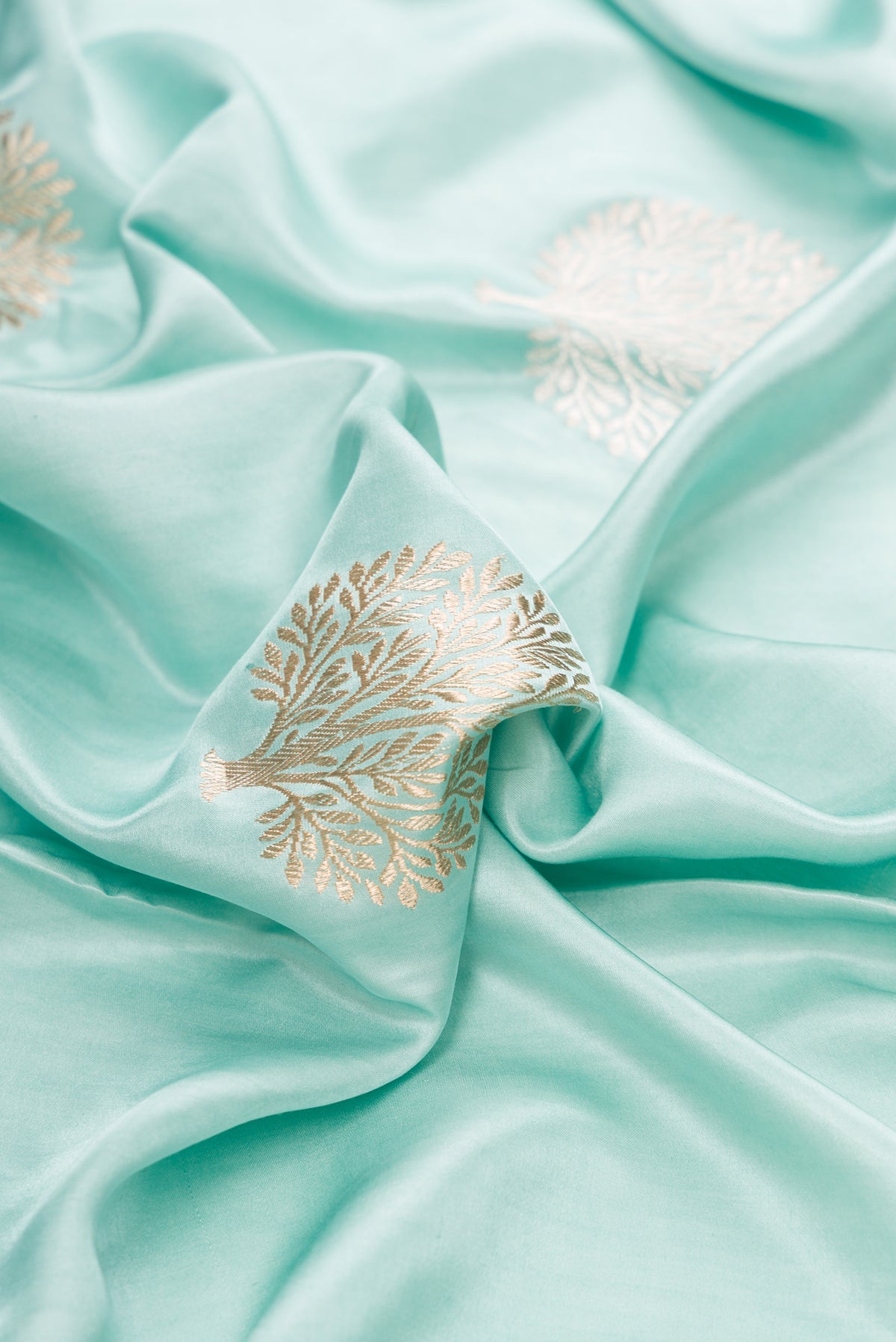 Close up of Pure Silk Light Blue Dual Tone Banarasi Saree with Zari Butta on the body and Zari Border.  displaying folds