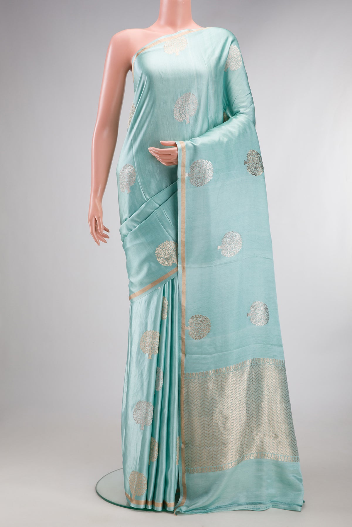 Pure Silk Light Blue Dual Tone Banarasi Saree with Zari Butta on the body and Zari Border.  displayed on a mannequin