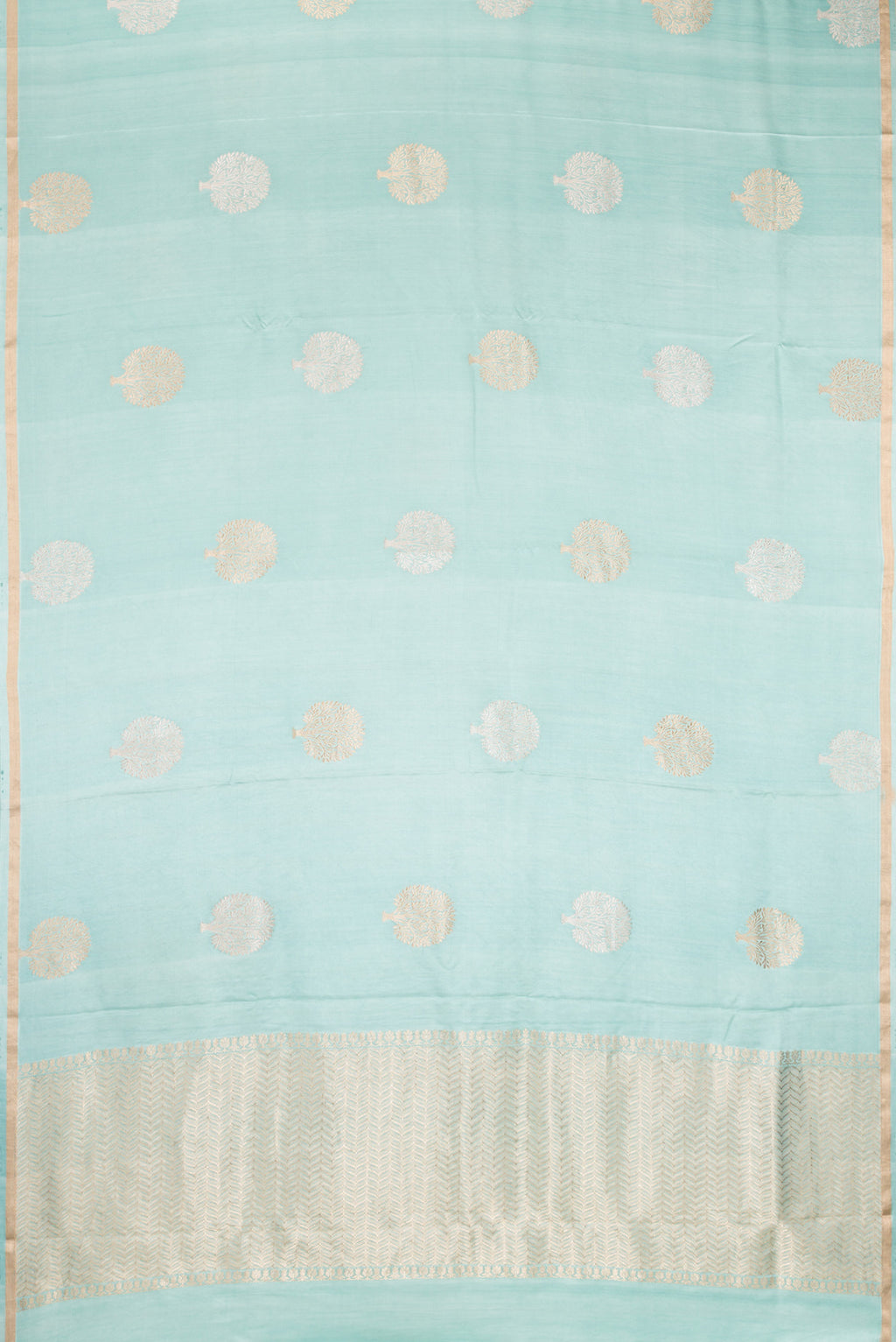 Flat view of Pure Silk Light Blue Dual Tone Banarasi Saree with Zari Butta on the body and Zari Border. 