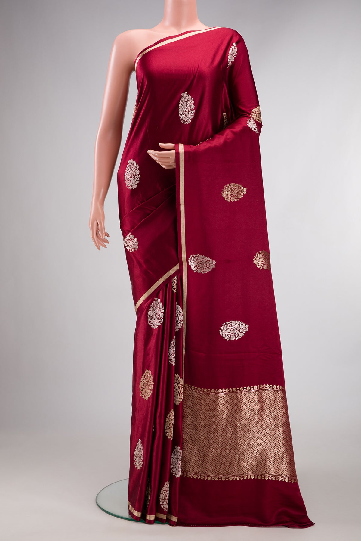 Pure Silk Maroon Dual Tone Banarasi Saree with Zari Butta on the body and Zari Border.  displayed on a mannequin